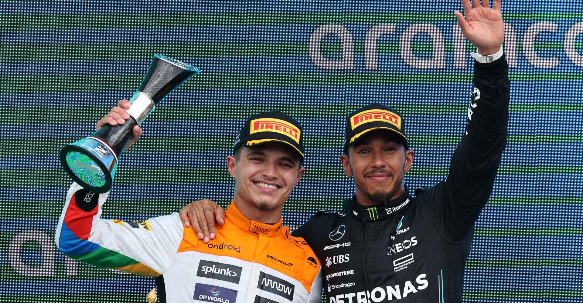 Lando Norris, McLaren, 2nd position, and Sir Lewis Hamilton, Mercedes-AMG, 3rd position, on the podium