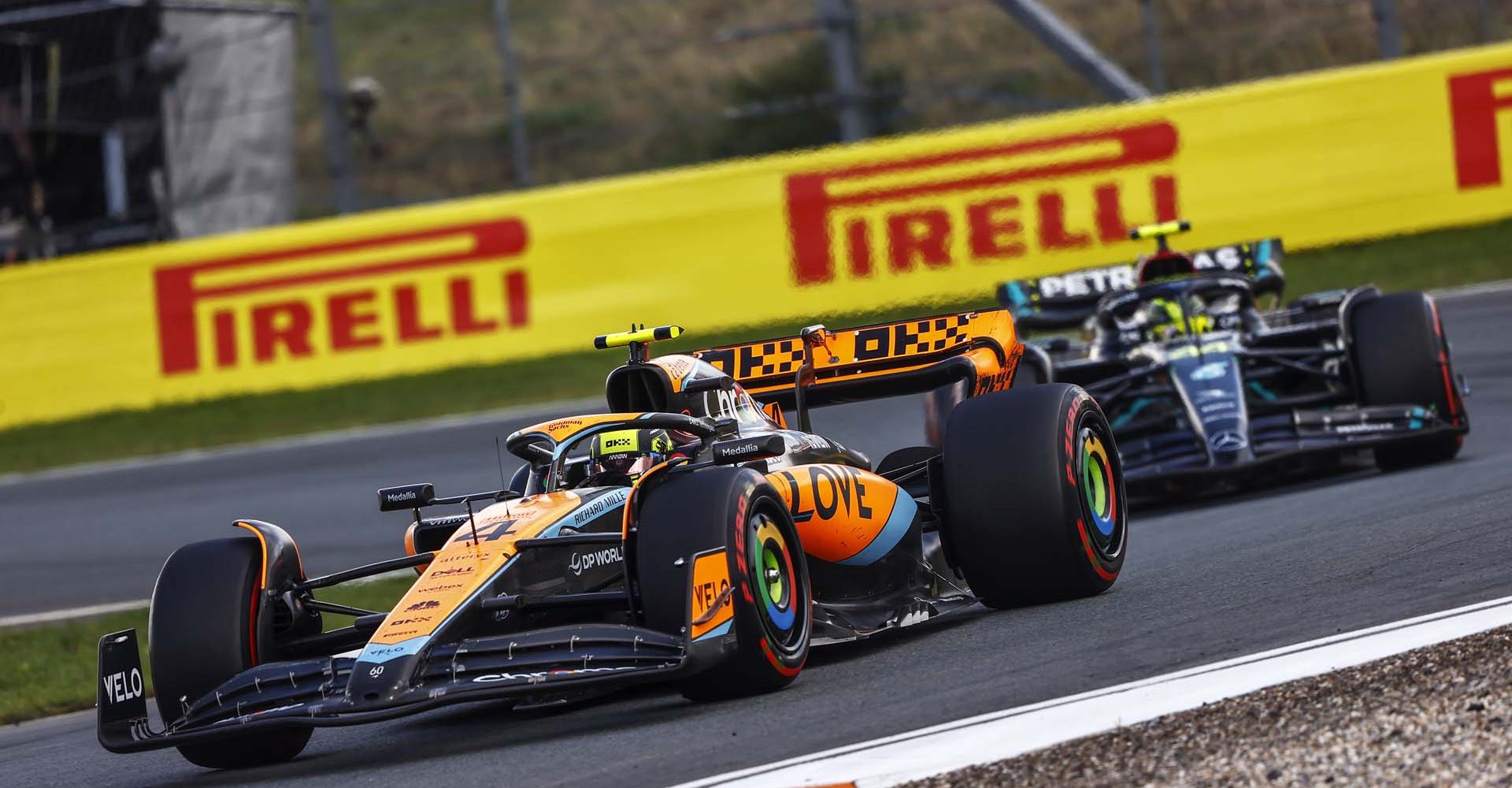 CIRCUIT ZANDVOORT, NETHERLANDS - AUGUST 27: Lando Norris, McLaren MCL60, leads Sir Lewis Hamilton, Mercedes F1 W14 during the Dutch GP at Circuit Zandvoort on Sunday August 27, 2023 in North Holland, Netherlands. (Photo by Andy Hone / LAT Images)