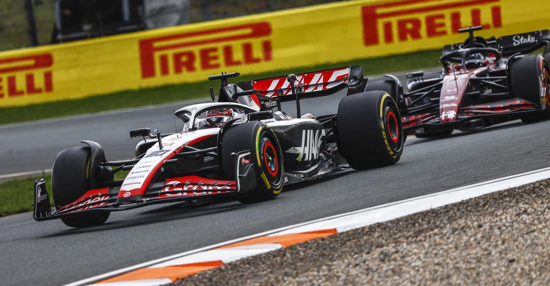 CIRCUIT ZANDVOORT, NETHERLANDS - AUGUST 27: Kevin Magnussen, Haas VF-23, leads Valtteri Bottas, Alfa Romeo C43 during the Dutch GP at Circuit Zandvoort on Sunday August 27, 2023 in North Holland, Netherlands. (Photo by Andy Hone / LAT Images)