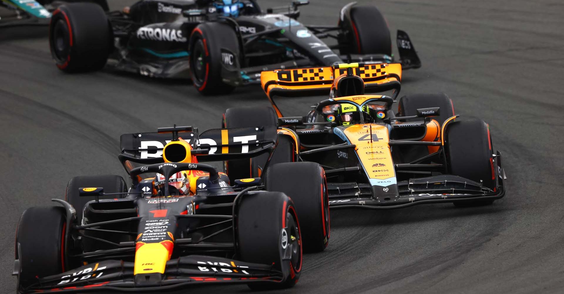 CIRCUIT ZANDVOORT, NETHERLANDS - AUGUST 27: Max Verstappen, Red Bull Racing RB19, leads Lando Norris, McLaren MCL60, and George Russell, Mercedes F1 W14 during the Dutch GP at Circuit Zandvoort on Sunday August 27, 2023 in North Holland, Netherlands. (Photo by Andy Hone / LAT Images)