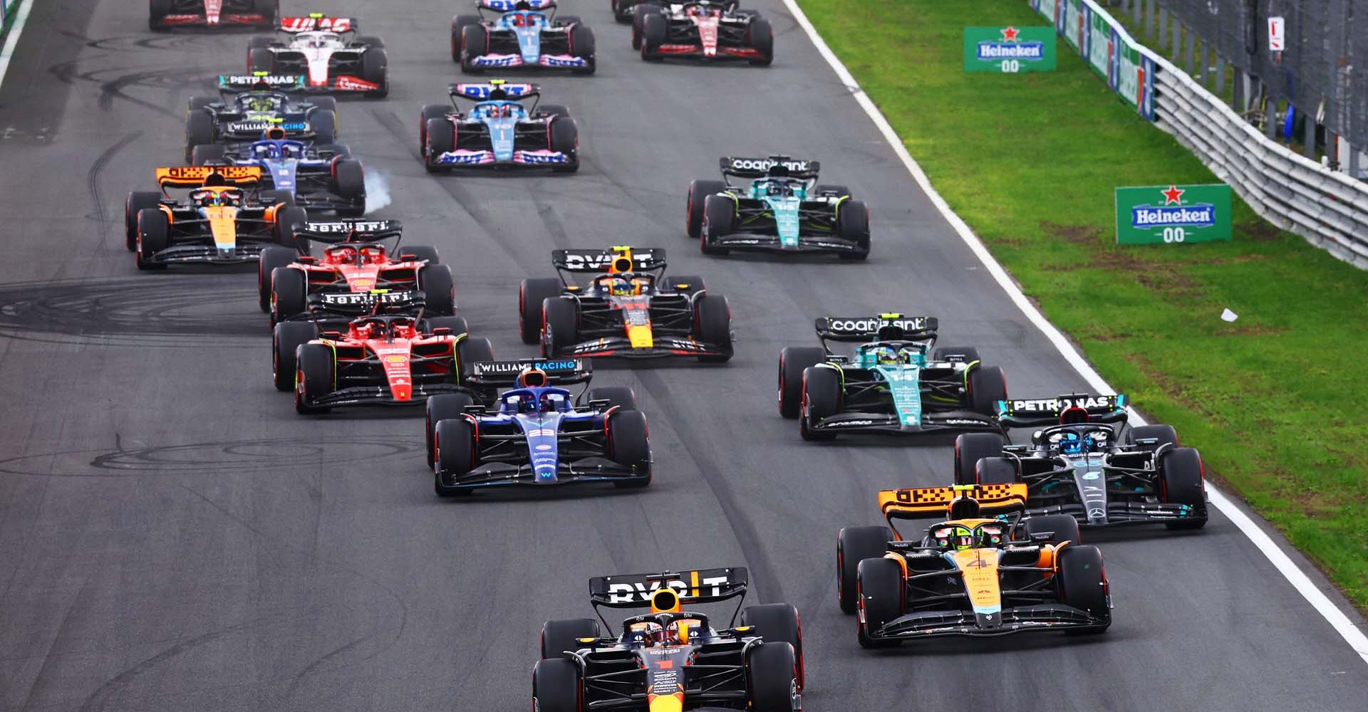 ZANDVOORT, NETHERLANDS - AUGUST 27: Max Verstappen of the Netherlands driving the (1) Oracle Red Bull Racing RB19 leads Lando Norris of Great Britain driving the (4) McLaren MCL60 Mercedes, George Russell of Great Britain driving the (63) Mercedes AMG Petronas F1 Team W14 and the rest of the field into turn one at the start during the F1 Grand Prix of The Netherlands at Circuit Zandvoort on August 27, 2023 in Zandvoort, Netherlands. (Photo by Mark Thompson/Getty Images) // Getty Images / Red Bull Content Pool // SI202308270586 // Usage for editorial use only //