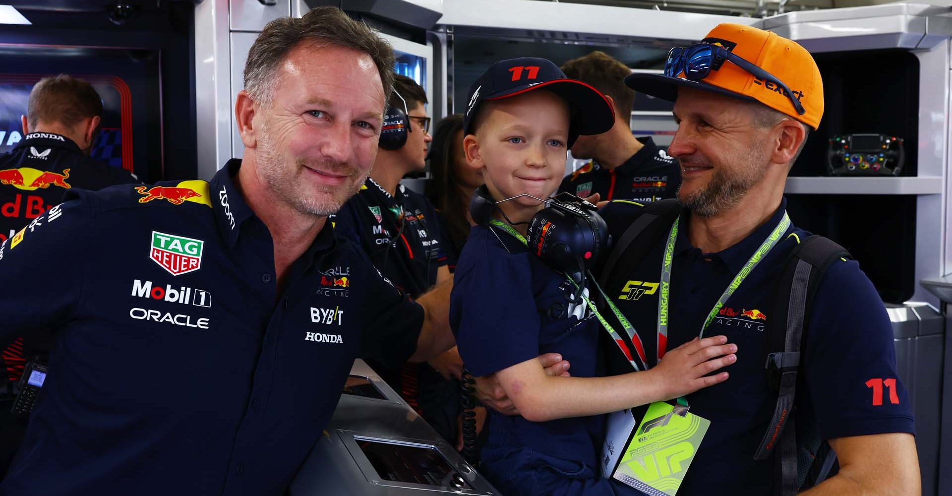 BUDAPEST, HUNGARY - JULY 21: Red Bull Racing Team Principal Christian Horner poses for a photo with a young fan in the garage during practice ahead of the F1 Grand Prix of Hungary at Hungaroring on July 21, 2023 in Budapest, Hungary. (Photo by Mark Thompson/Getty Images)