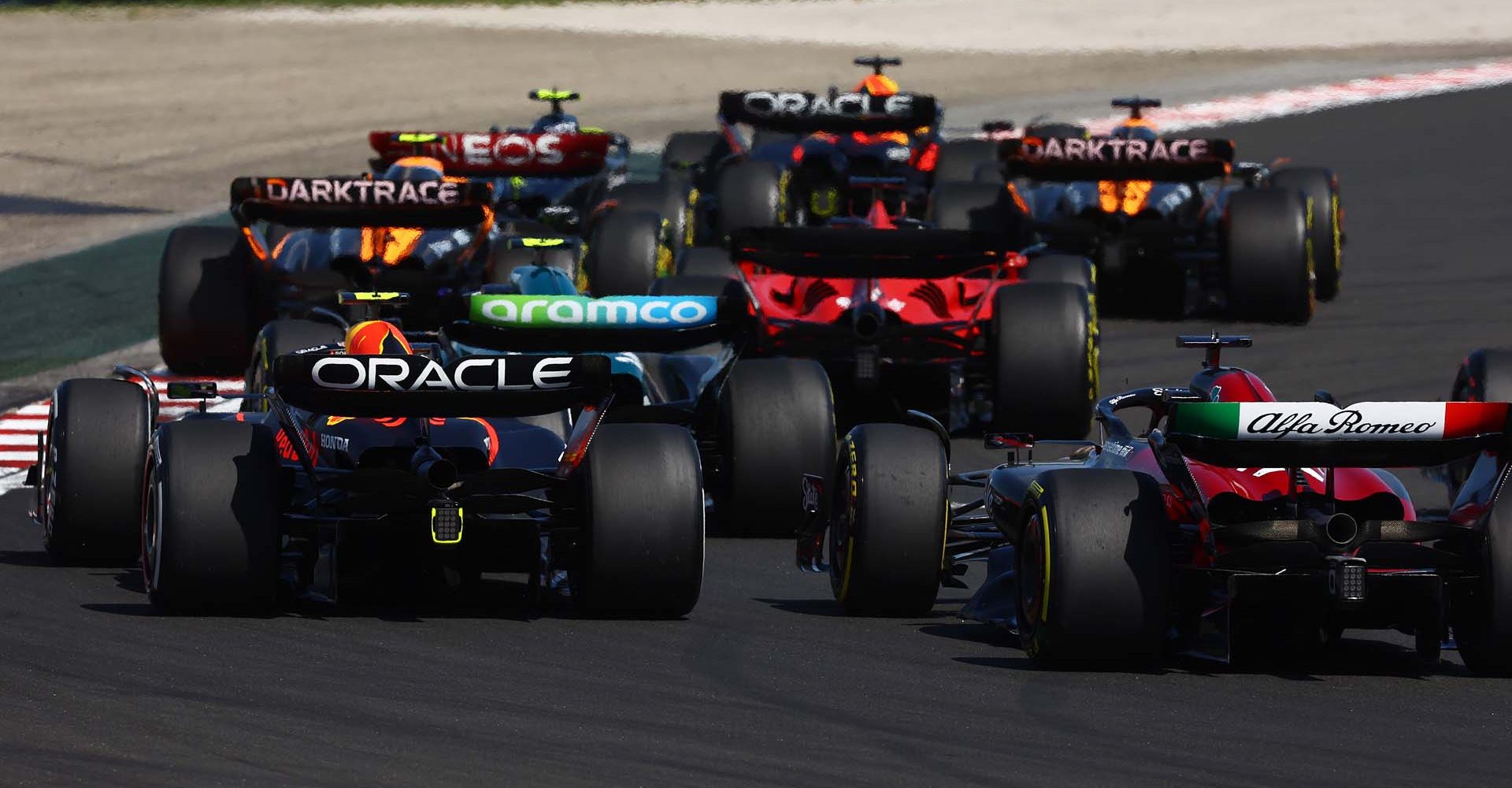 BUDAPEST, HUNGARY - JULY 23: Sergio Perez of Mexico driving the (11) Oracle Red Bull Racing RB19 and Valtteri Bottas of Finland driving the (77) Alfa Romeo F1 C43 Ferrari battle for track position during the F1 Grand Prix of Hungary at Hungaroring on July 23, 2023 in Budapest, Hungary. (Photo by Mark Thompson/Getty Images)