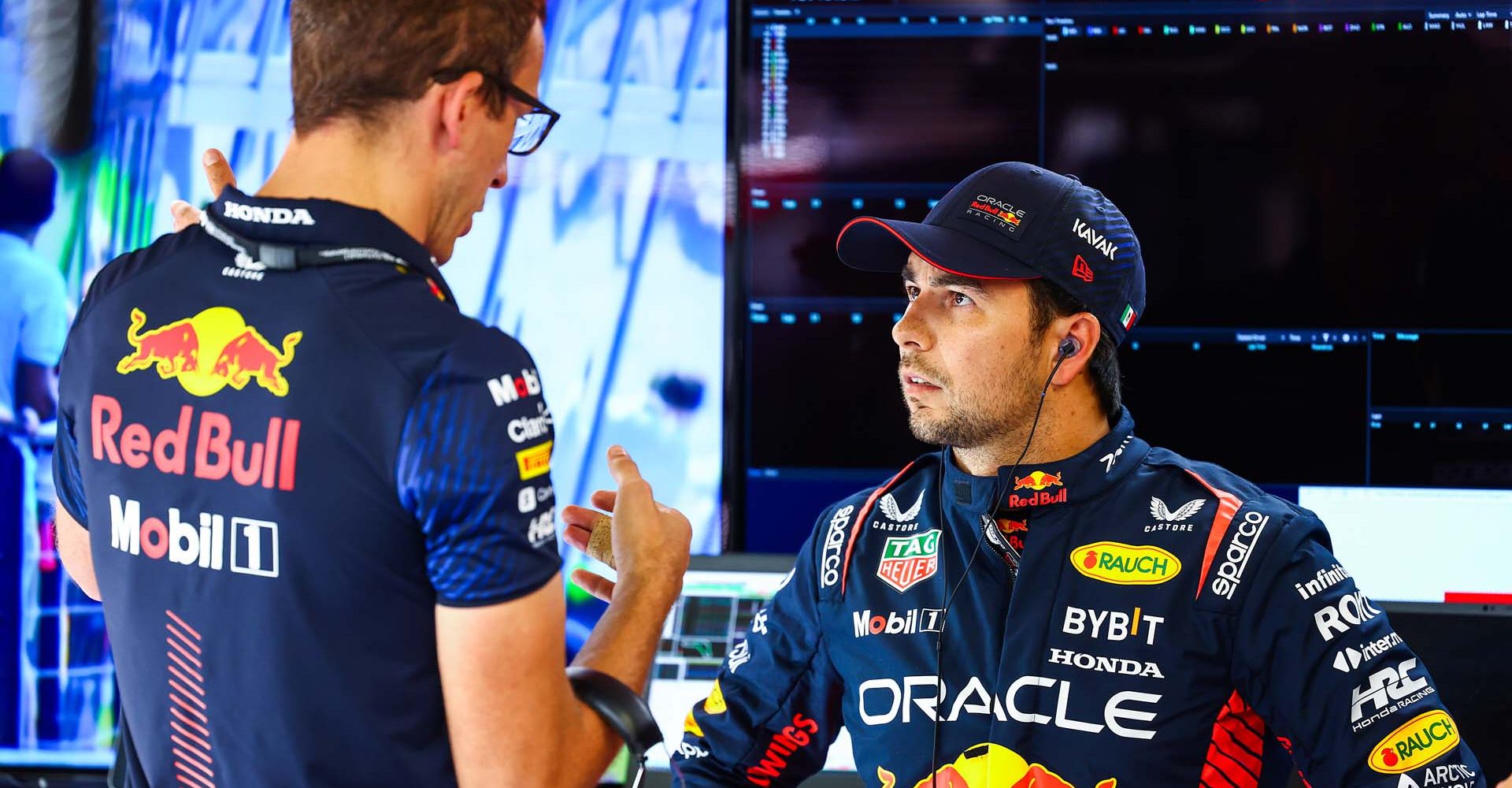 MONZA, ITALY - SEPTEMBER 02: Sergio Perez of Mexico and Oracle Red Bull Racing talks with race engineer Hugh Bird in the garage during qualifying ahead of the F1 Grand Prix of Italy at Autodromo Nazionale Monza on September 02, 2023 in Monza, Italy. (Photo by Mark Thompson/Getty Images) // Getty Images / Red Bull Content Pool // SI202309020278 // Usage for editorial use only //