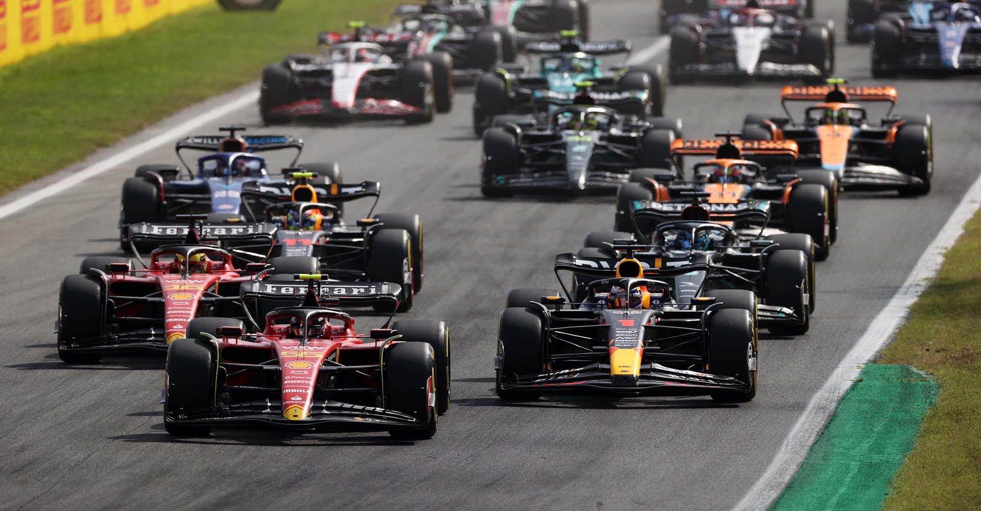 MONZA, ITALY - SEPTEMBER 03: Carlos Sainz of Spain driving (55) the Ferrari SF-23 leads Max Verstappen of the Netherlands driving the (1) Oracle Red Bull Racing RB19 and the rest of the field at the start during the F1 Grand Prix of Italy at Autodromo Nazionale Monza on September 03, 2023 in Monza, Italy. (Photo by Ryan Pierse/Getty Images) // Getty Images / Red Bull Content Pool // SI202309030247 // Usage for editorial use only //