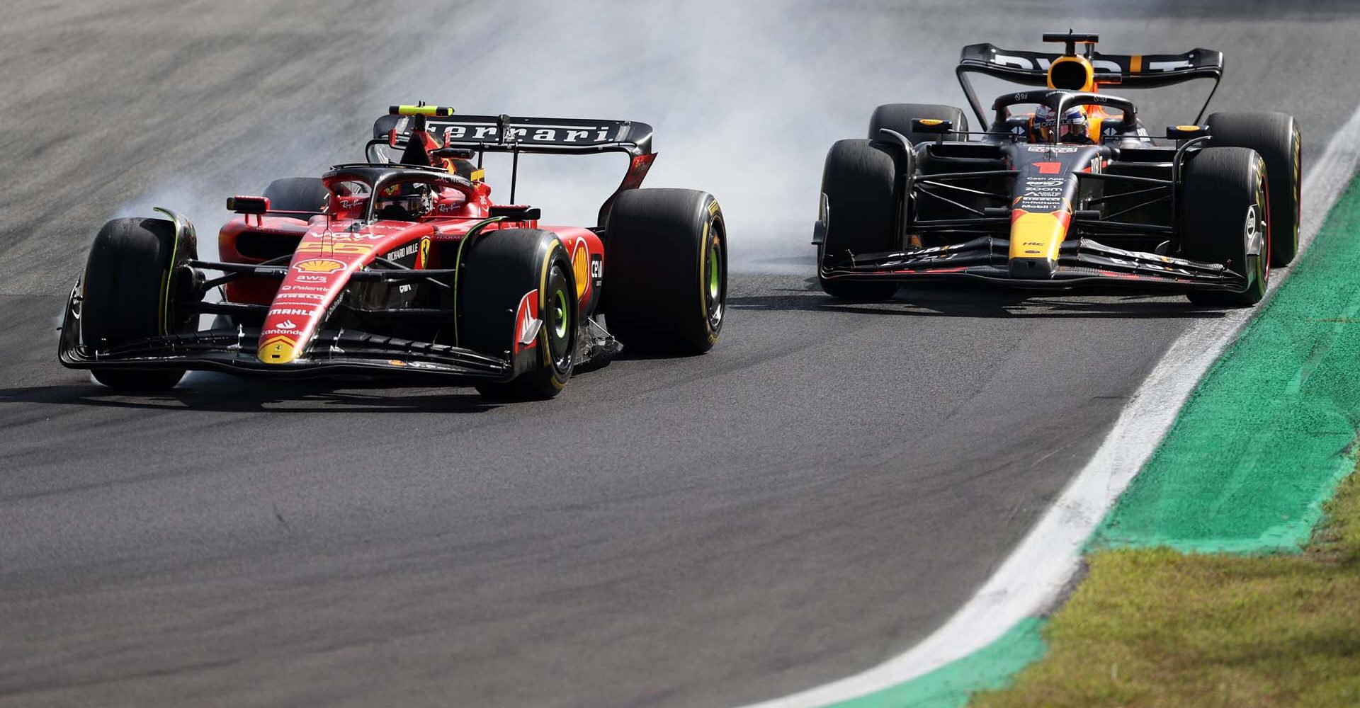 MONZA, ITALY - SEPTEMBER 03: Carlos Sainz of Spain driving (55) the Ferrari SF-23 locks a wheel under braking as he defends his track position from Max Verstappen of the Netherlands driving the (1) Oracle Red Bull Racing RB19 during the F1 Grand Prix of Italy at Autodromo Nazionale Monza on September 03, 2023 in Monza, Italy. (Photo by Ryan Pierse/Getty Images) // Getty Images / Red Bull Content Pool // SI202309030272 // Usage for editorial use only //