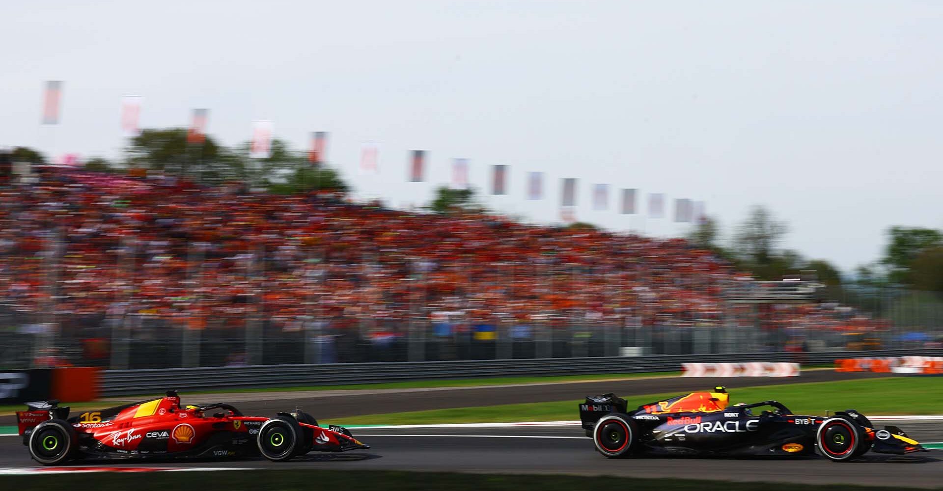 MONZA, ITALY - SEPTEMBER 03: Sergio Perez of Mexico driving the (11) Oracle Red Bull Racing RB19 leads Charles Leclerc of Monaco driving the (16) Ferrari SF-23 during the F1 Grand Prix of Italy at Autodromo Nazionale Monza on September 03, 2023 in Monza, Italy. (Photo by Mark Thompson/Getty Images) // Getty Images / Red Bull Content Pool // SI202309030284 // Usage for editorial use only //