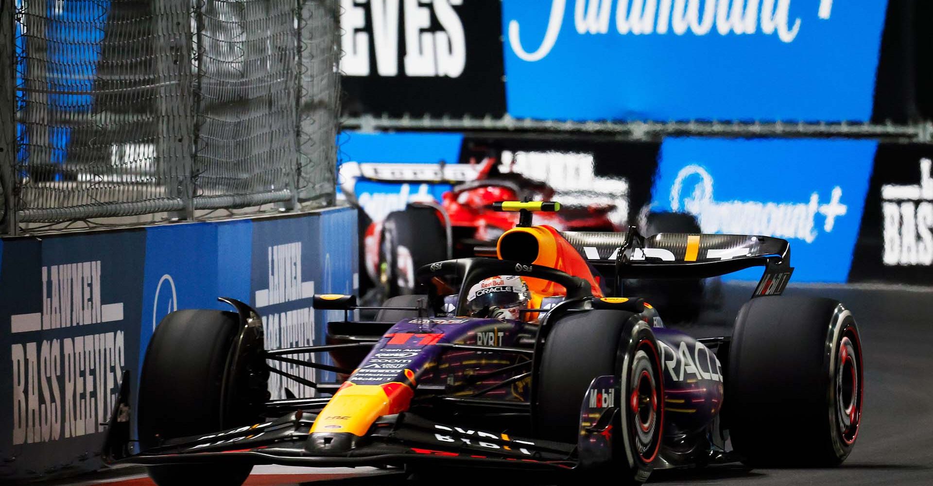 LAS VEGAS, NEVADA - NOVEMBER 18: Sergio Perez of Mexico driving the (11) Oracle Red Bull Racing RB19 leads Charles Leclerc of Monaco driving the (16) Ferrari SF-23 during the F1 Grand Prix of Las Vegas at Las Vegas Strip Circuit on November 18, 2023 in Las Vegas, Nevada. (Photo by Chris Graythen/Getty Images) // Getty Images / Red Bull Content Pool // SI202311190123 // Usage for editorial use only //