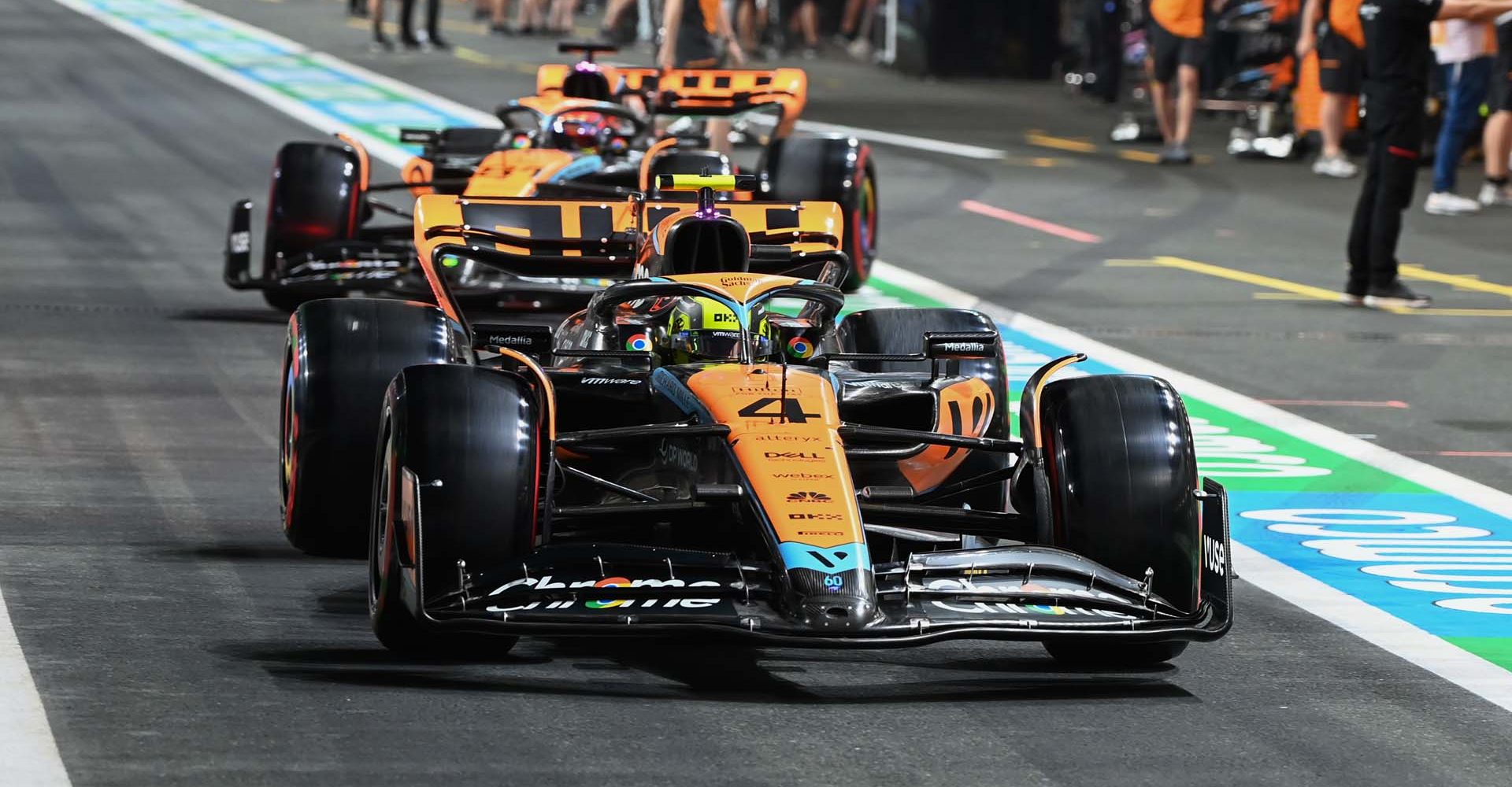 Lando Norris, McLaren MCL60, leads Oscar Piastri, McLaren MCL60, in the pit lane