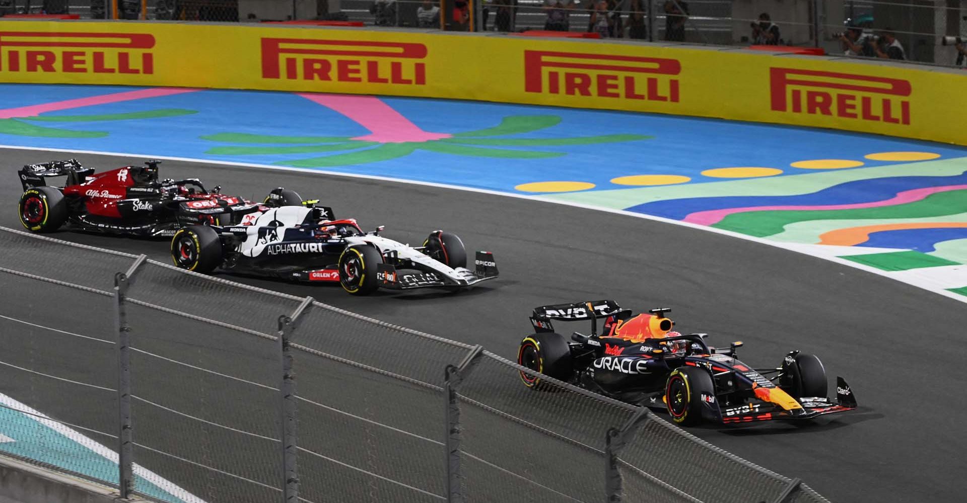 JEDDAH STREET CIRCUIT, SAUDI ARABIA - MARCH 19: Max Verstappen, Red Bull Racing RB19, leads Yuki Tsunoda, AlphaTauri AT04, and Valtteri Bottas, Alfa Romeo C43 during the Saudi Arabian GP at Jeddah Street Circuit on Sunday March 19, 2023 in Jeddah, Saudi Arabia. (Photo by Mark Sutton / LAT Images)