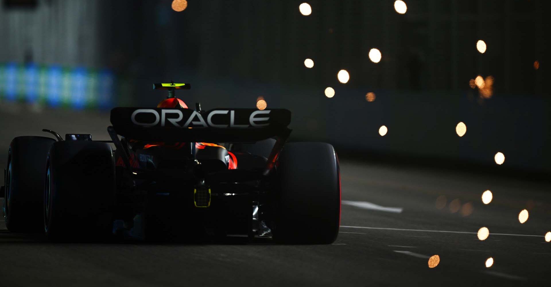 SINGAPORE, SINGAPORE - SEPTEMBER 16: Sparks fly behind the car of Sergio Perez of Mexico driving the (11) Oracle Red Bull Racing RB19 during qualifying ahead of the F1 Grand Prix of Singapore at Marina Bay Street Circuit on September 16, 2023 in Singapore, Singapore. (Photo by Clive Mason/Getty Images) // Getty Images / Red Bull Content Pool // SI202309160534 // Usage for editorial use only //