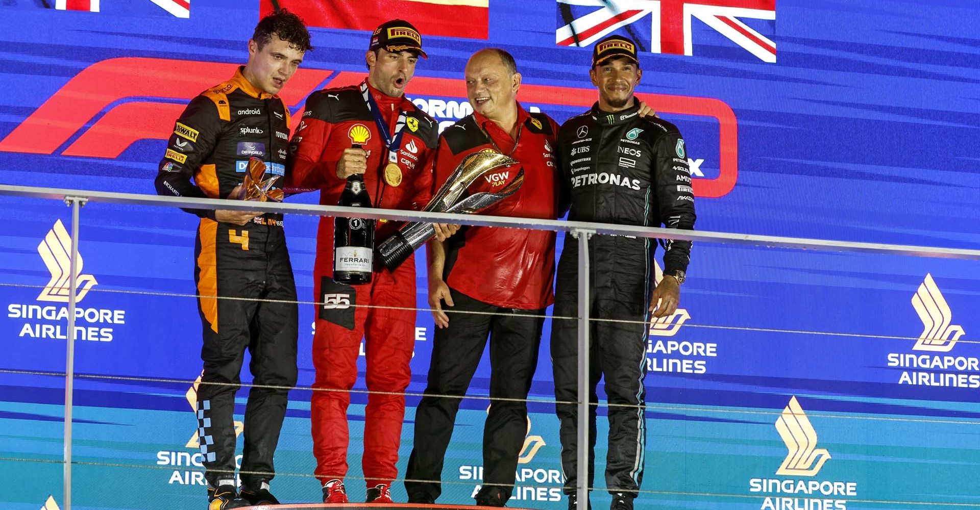 MARINA BAY STREET CIRCUIT, SINGAPORE - SEPTEMBER 17: Lando Norris, McLaren, 2nd position, Carlos Sainz, Scuderia Ferrari, 1st position, Frederic Vasseur, Team Principal and General Manager, Scuderia Ferrari, and Sir Lewis Hamilton, Mercedes-AMG, 3rd position, on the podium during the Singapore GP at Marina Bay Street Circuit on Sunday September 17, 2023 in Singapore, Singapore. (Photo by Steven Tee / LAT Images)