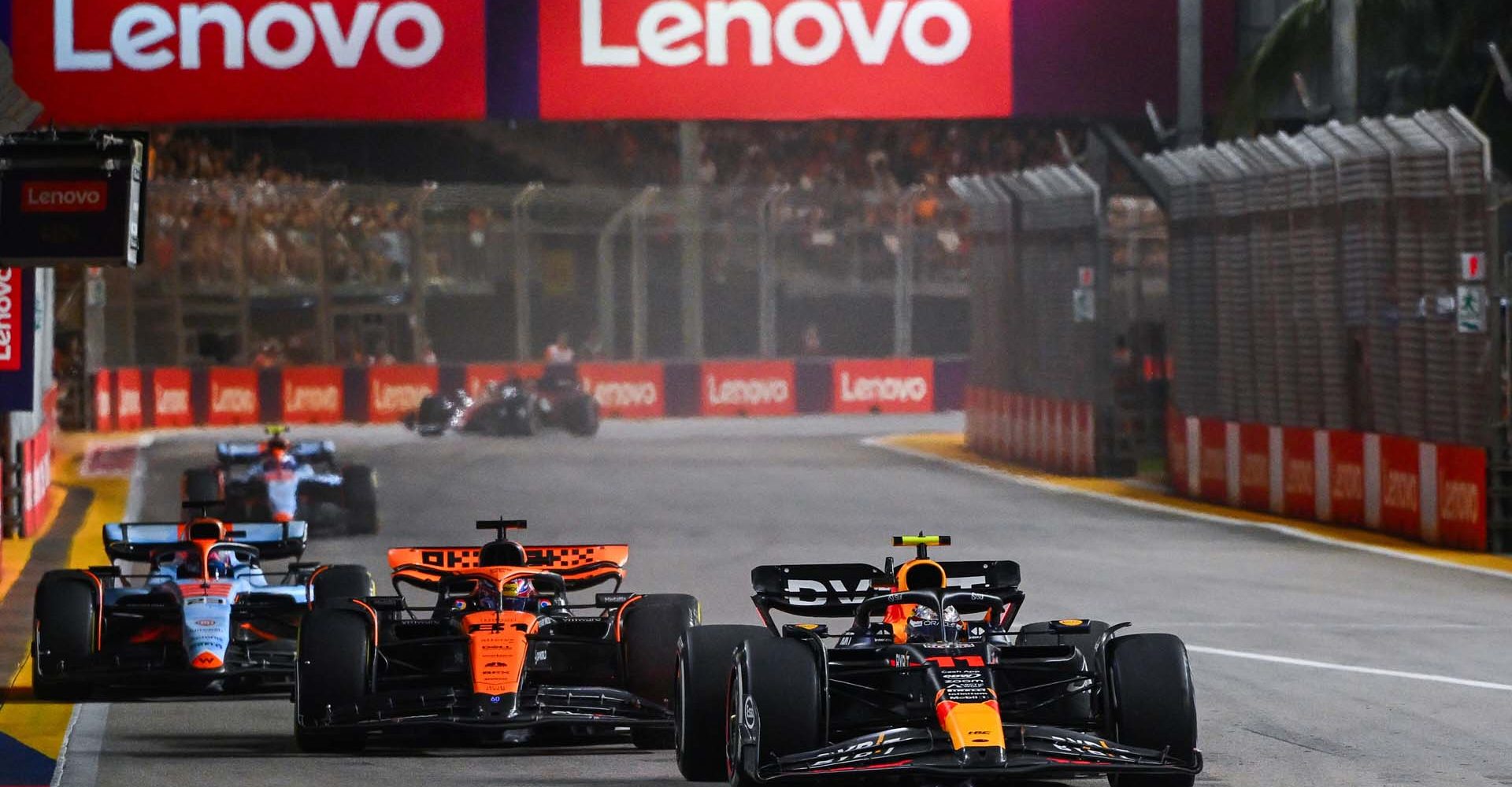 SINGAPORE, SINGAPORE - SEPTEMBER 17: Sergio Perez of Mexico driving the (11) Oracle Red Bull Racing RB19 leads Oscar Piastri of Australia driving the (81) McLaren MCL60 Mercedes during the F1 Grand Prix of Singapore at Marina Bay Street Circuit on September 17, 2023 in Singapore, Singapore. (Photo by Clive Mason/Getty Images) // Getty Images / Red Bull Content Pool // SI202309170243 // Usage for editorial use only //