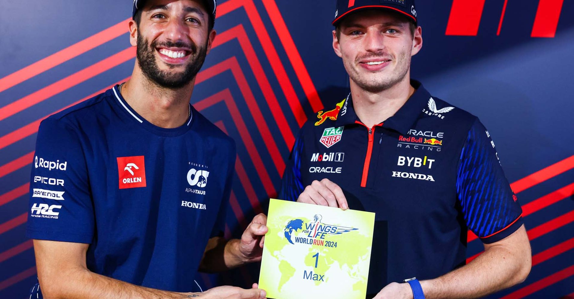 AUSTIN, TEXAS - OCTOBER 19: Daniel Ricciardo of Australia and Scuderia AlphaTauri presents Max Verstappen of the Netherlands and Oracle Red Bull Racing with the Number 1 for the Wings for Life World Run 2024 during previews ahead of the F1 Grand Prix of United States at Circuit of The Americas on October 19, 2023 in Austin, Texas. (Photo by Mark Thompson/Getty Images) // Getty Images / Red Bull Content Pool // SI202310200059 // Usage for editorial use only //