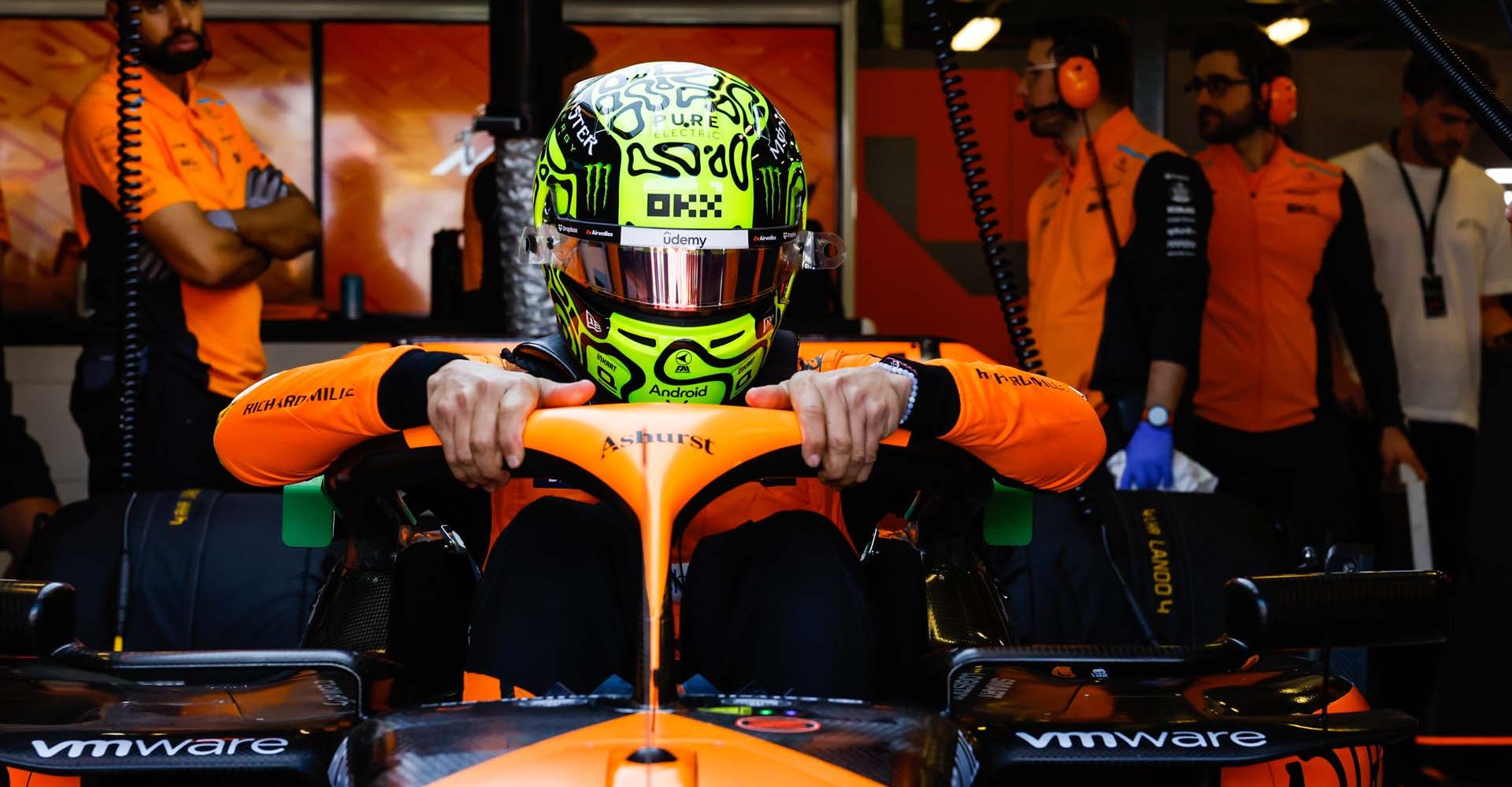 Lando Norris, McLaren MCL38, settles into his cockpit