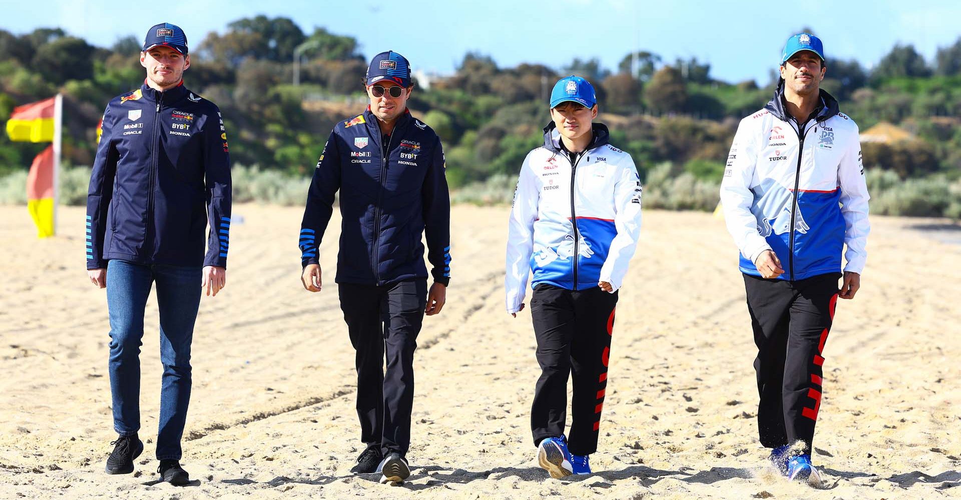 MELBOURNE, AUSTRALIA - MARCH 20: Max Verstappen of the Netherlands and Oracle Red Bull Racing, Sergio Perez of Mexico and Oracle Red Bull Racing, Yuki Tsunoda of Japan and Visa Cash App RB and Daniel Ricciardo of Australia and Visa Cash App RB walk on the beach during previews ahead of the F1 Grand Prix of Australia at Albert Park Circuit on March 20, 2024 in Melbourne, Australia. (Photo by Mark Thompson/Getty Images) // Getty Images / Red Bull Content Pool // SI202403200973 // Usage for editorial use only //