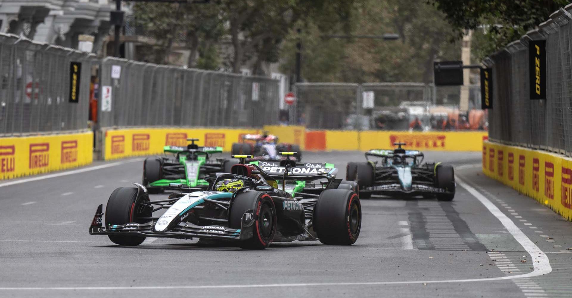 Sir Lewis Hamilton, Mercedes F1 W15, leads Zhou Guanyu, Stake F1 Team KICK Sauber C44, Lance Stroll, Aston Martin AMR24, and Valtteri Bottas, Stake F1 Team KICK Sauber C44 during the Azerbaijan GP at Baku City Circuit