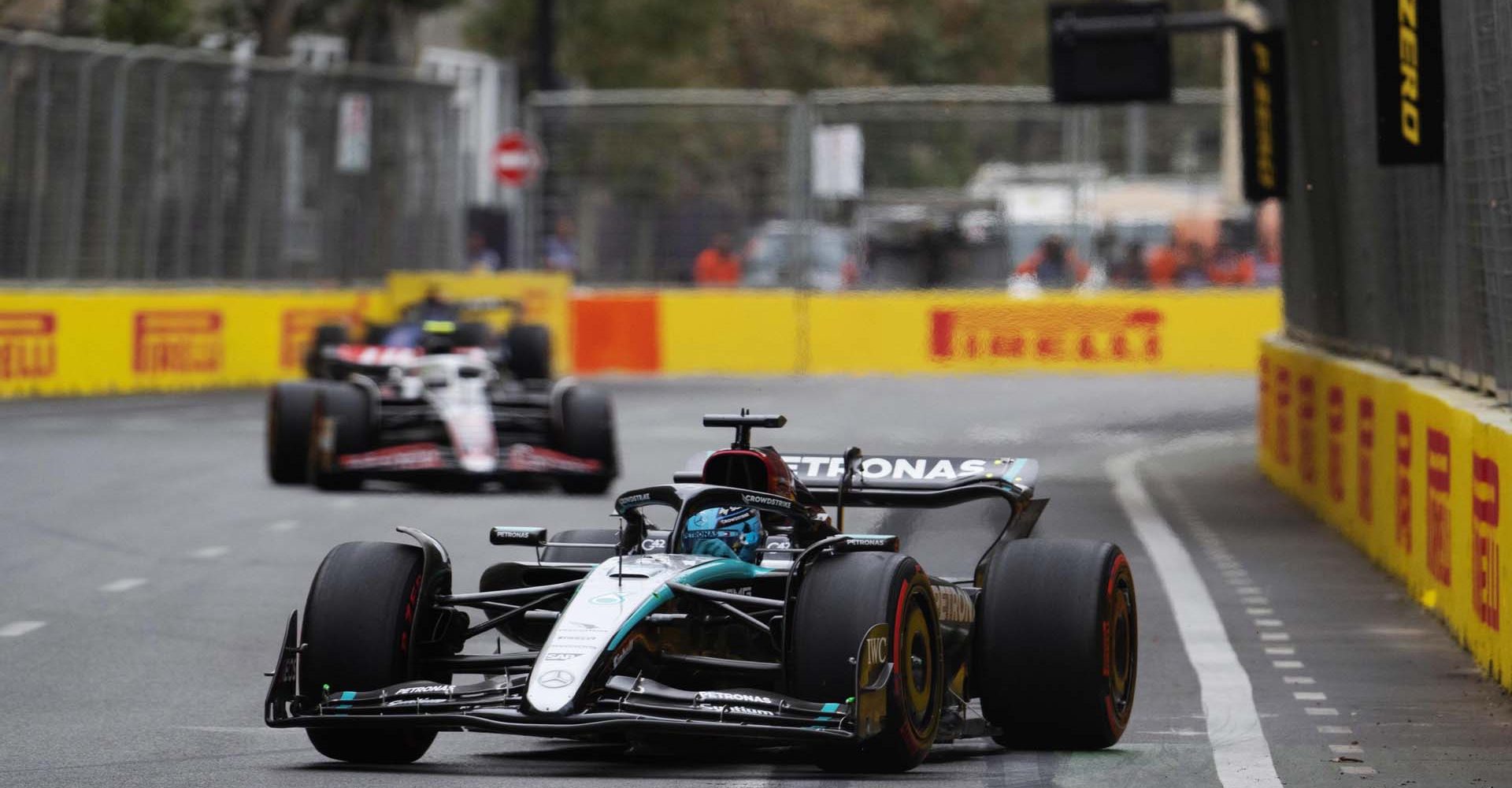 George Russell, Mercedes F1 W15, leads Nico Hulkenberg, Haas VF-24 during the Azerbaijan GP at Baku City Circuit