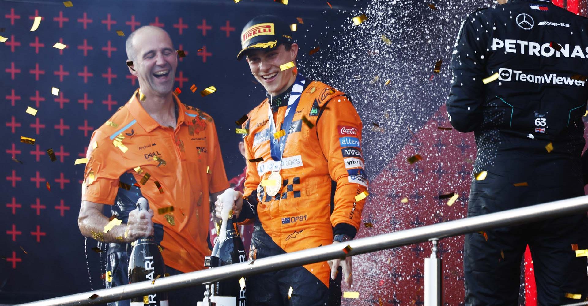 Oscar Piastri, McLaren F1 Team, 1st position, celebrates with his teammate on the podium as confetti falls