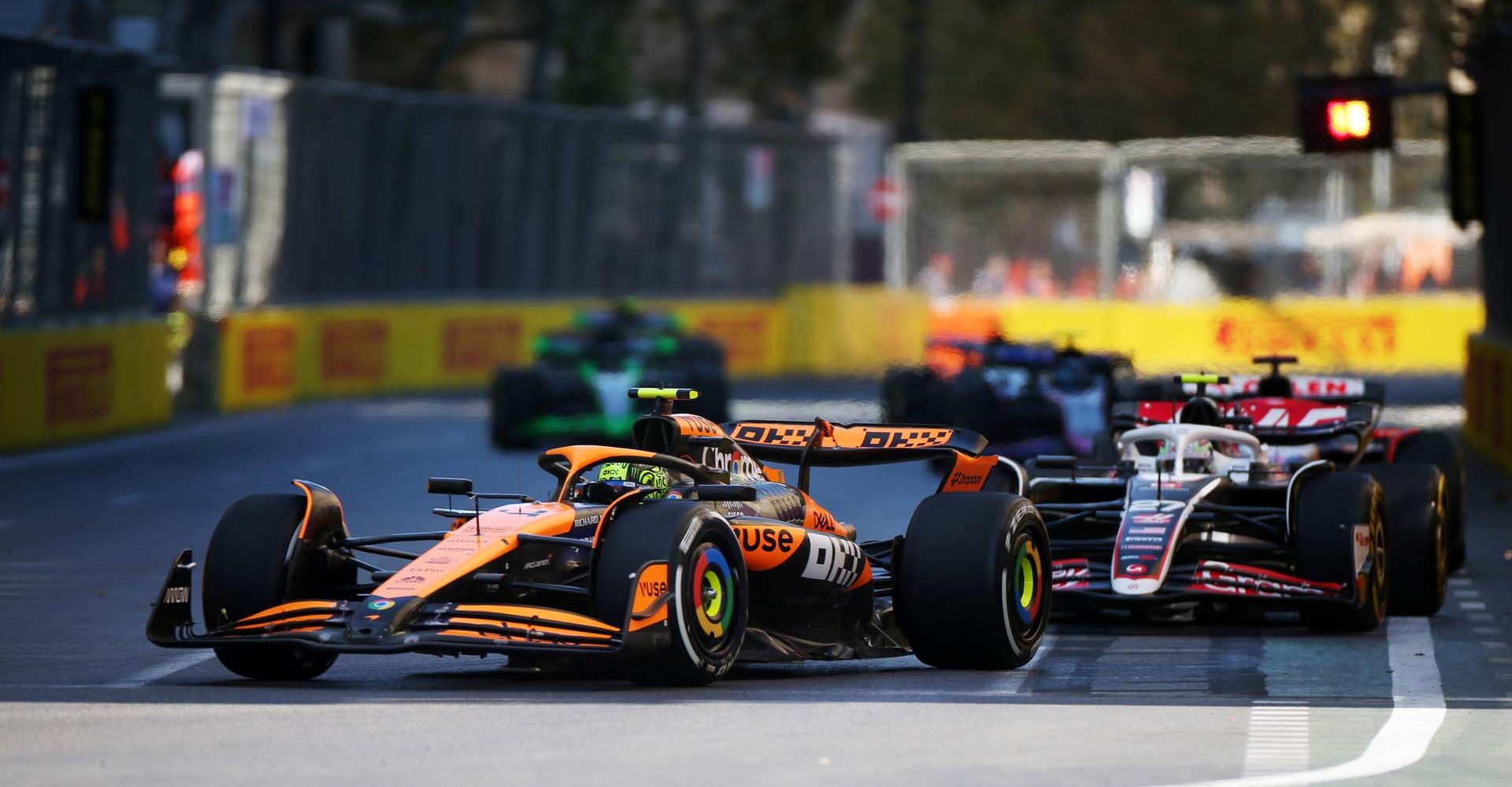 Lando Norris, McLaren MCL38, leads Nico Hulkenberg, Haas VF-24 during the Azerbaijan GP at Baku City Circuit