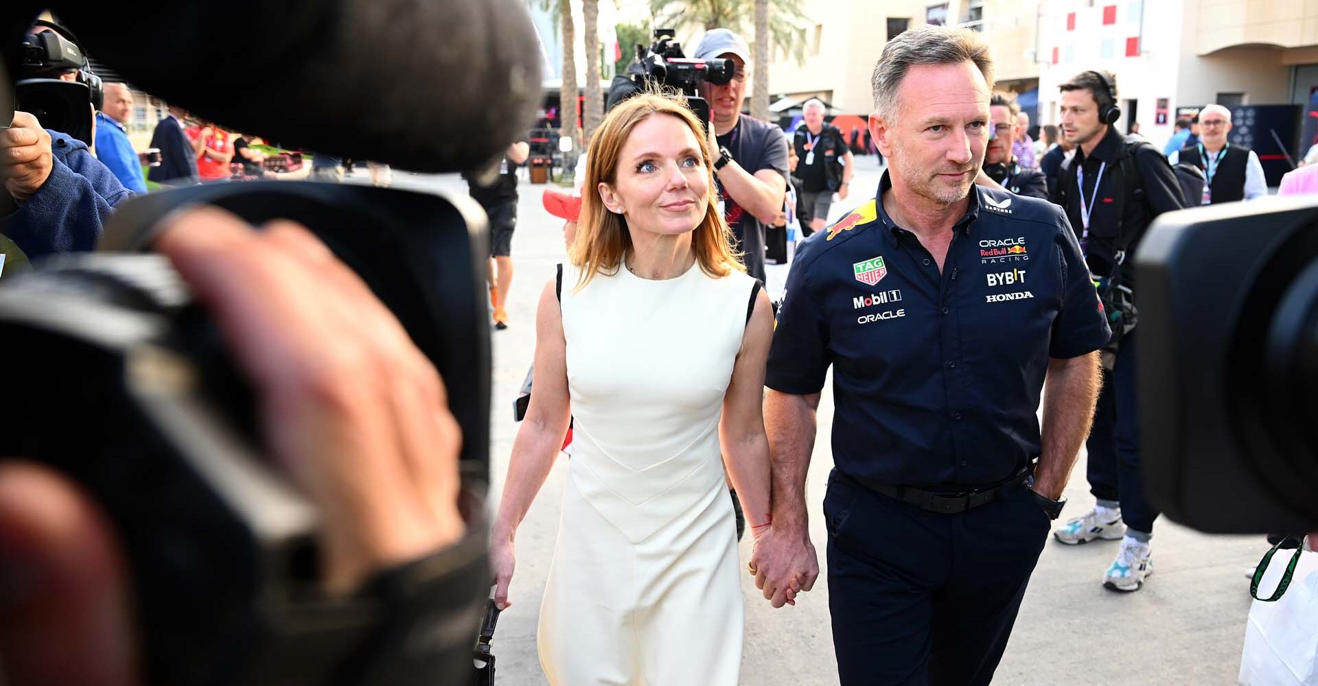 BAHRAIN, BAHRAIN - MARCH 02: Oracle Red Bull Racing Team Principal Christian Horner and Geri Horner walk in the Paddock holding hands prior to the F1 Grand Prix of Bahrain at Bahrain International Circuit on March 02, 2024 in Bahrain, Bahrain. (Photo by Clive Mason/Getty Images) // Getty Images / Red Bull Content Pool // SI202403020237 // Usage for editorial use only //