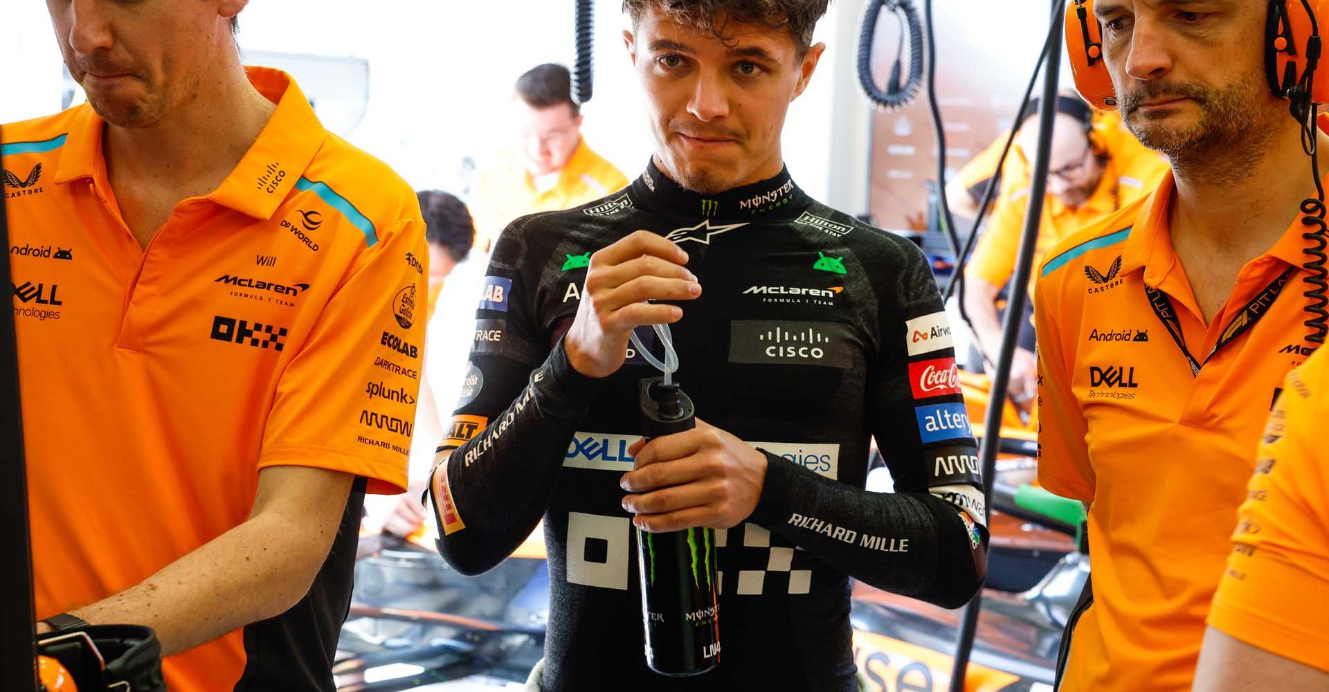 Lando Norris, McLaren F1 Team, works with colleagues in the garage