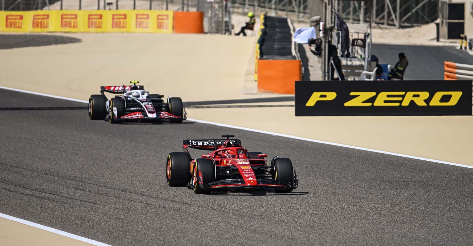 BAHRAIN INTERNATIONAL CIRCUIT, BAHRAIN - FEBRUARY 22: Charles Leclerc, Ferrari SF-24, and Nico Hulkenberg, Haas VF-24 during the Pre-Season Test at Bahrain International Circuit on Thursday February 22, 2024 in Sakhir, Bahrain. (Photo by Simon Galloway / LAT Images)