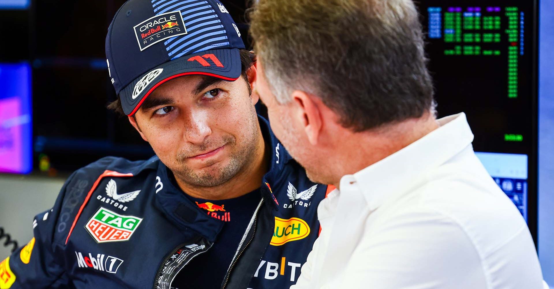 BAHRAIN, BAHRAIN - FEBRUARY 22: Sergio Perez of Mexico and Oracle Red Bull Racing talks with Oracle Red Bull Racing Team Principal Christian Horner in the garage during day two of F1 Testing at Bahrain International Circuit on February 22, 2024 in Bahrain, Bahrain. (Photo by Mark Thompson/Getty Images) // Getty Images / Red Bull Content Pool // SI202402220309 // Usage for editorial use only //