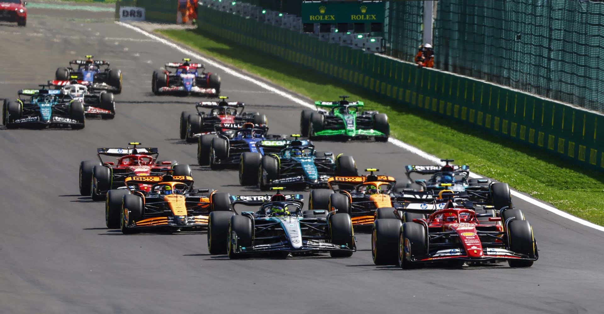 Charles Leclerc, Ferrari SF-24, leads Sir Lewis Hamilton, Mercedes F1 W15, Lando Norris, McLaren MCL38, George Russell, Mercedes F1 W15, Oscar Piastri, McLaren MCL38, and the rest of the field at the start