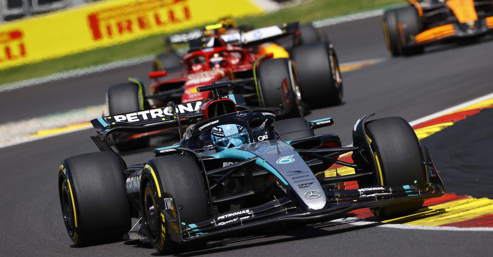 CIRCUIT DE SPA FRANCORCHAMPS, BELGIUM - JULY 28: George Russell, Mercedes F1 W15, leads Carlos Sainz, Ferrari SF-24 during the Belgian GP at Circuit de Spa Francorchamps on Sunday July 28, 2024 in Spa, Belgium. (Photo by Andy Hone / LAT Images)