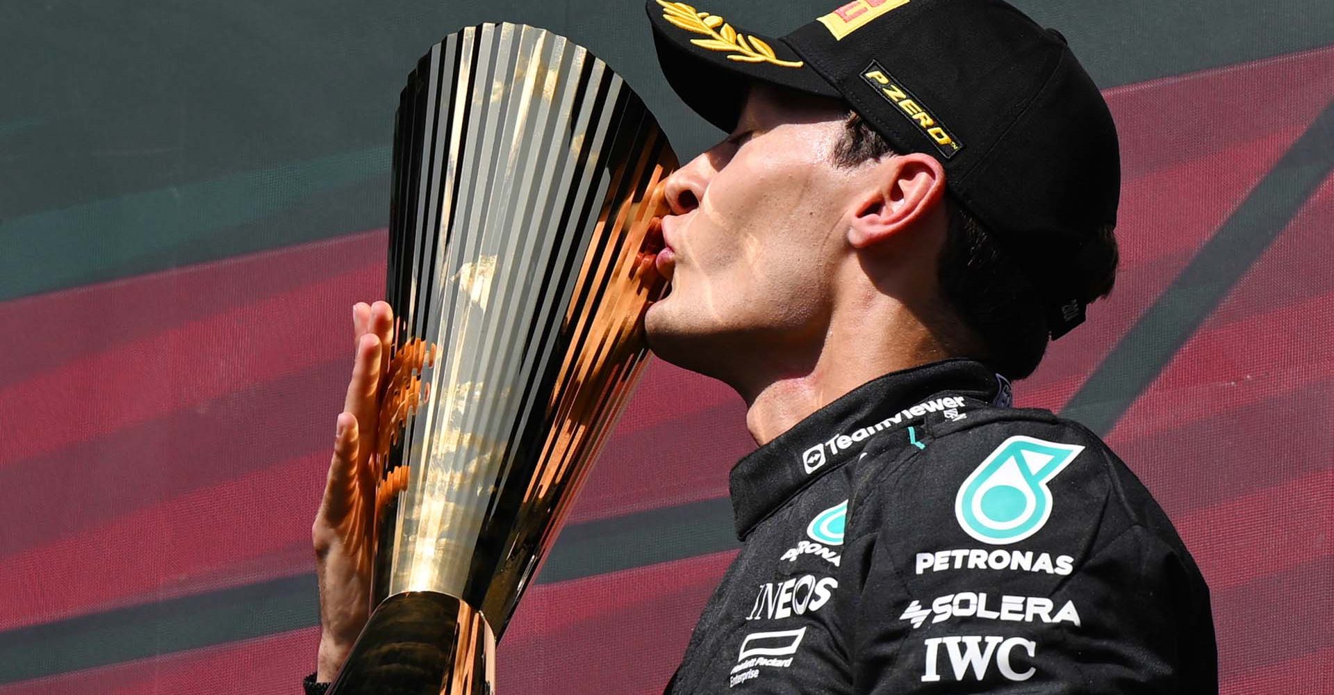 CIRCUIT DE SPA FRANCORCHAMPS, BELGIUM - JULY 28: George Russell, Mercedes-AMG F1 Team, 1st position, kisses the trophy in celebration during the Belgian GP at Circuit de Spa Francorchamps on Sunday July 28, 2024 in Spa, Belgium. (Photo by Sam Bagnall / LAT Images)