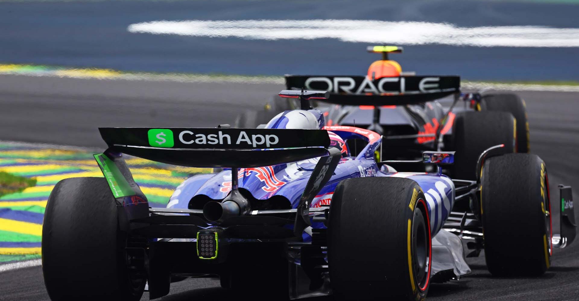 SAO PAULO, BRAZIL - NOVEMBER 02: Sergio Perez of Mexico driving the (11) Oracle Red Bull Racing RB20 leads Liam Lawson of New Zealand driving the (30) Visa Cash App RB VCARB 01 on track during the Sprint ahead of the F1 Grand Prix of Brazil at Autodromo Jose Carlos Pace on November 02, 2024 in Sao Paulo, Brazil. (Photo by Mark Thompson/Getty Images) // Getty Images / Red Bull Content Pool // SI202411020385 // Usage for editorial use only //