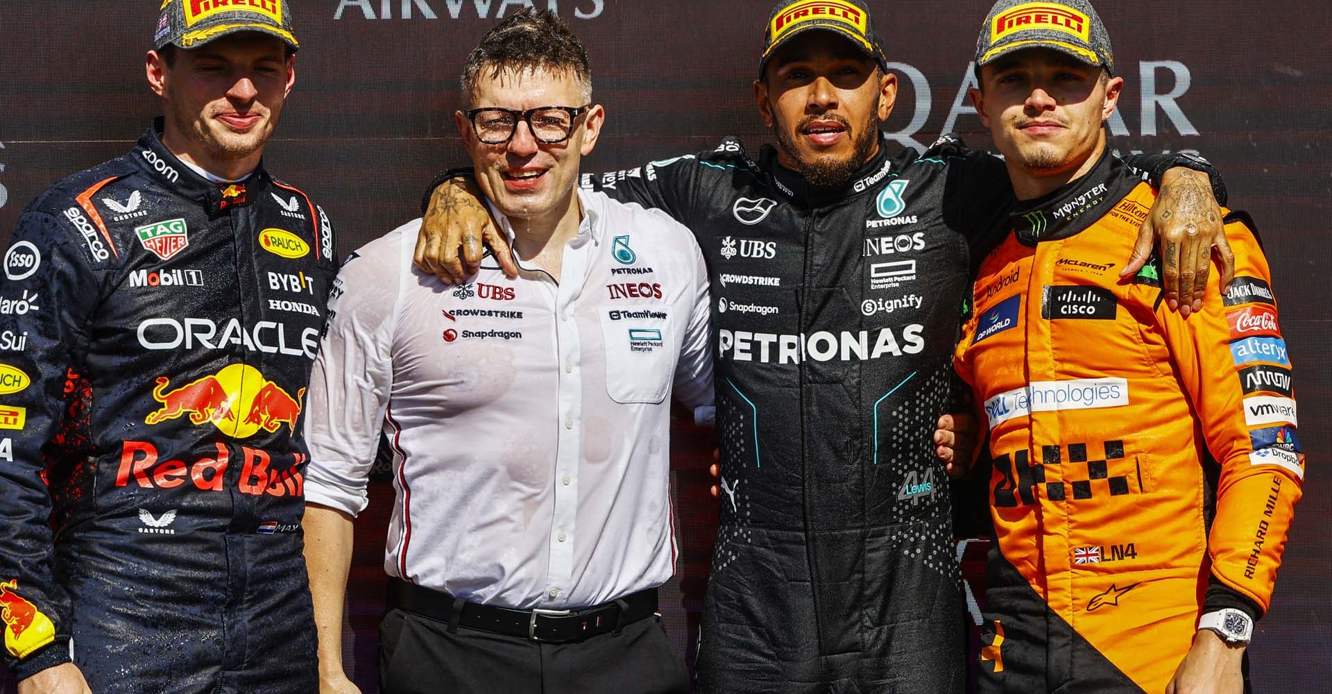 SILVERSTONE CIRCUIT, UNITED KINGDOM - JULY 07: Max Verstappen, Red Bull Racing, 2nd position, Peter Bonnington, Senior Race Engineer, Mercedes-AMG F1 Team, Sir Lewis Hamilton, Mercedes-AMG F1 Team, 1st position, and Lando Norris, McLaren F1 Team, 3rd position, on the podium during the British GP at Silverstone Circuit on Sunday July 07, 2024 in Northamptonshire, United Kingdom. (Photo by Andy Hone / LAT Images)