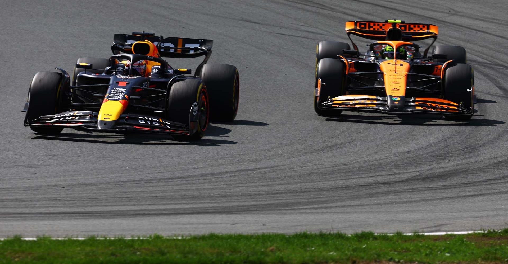 ZANDVOORT, NETHERLANDS - AUGUST 25: Max Verstappen of the Netherlands driving the (1) Oracle Red Bull Racing RB20 and Lando Norris of Great Britain driving the (4) McLaren MCL38 Mercedes battle for track position during the F1 Grand Prix of Netherlands at Circuit Zandvoort on August 25, 2024 in Zandvoort, Netherlands. (Photo by Mark Thompson/Getty Images) // Getty Images / Red Bull Content Pool // SI202408250211 // Usage for editorial use only //