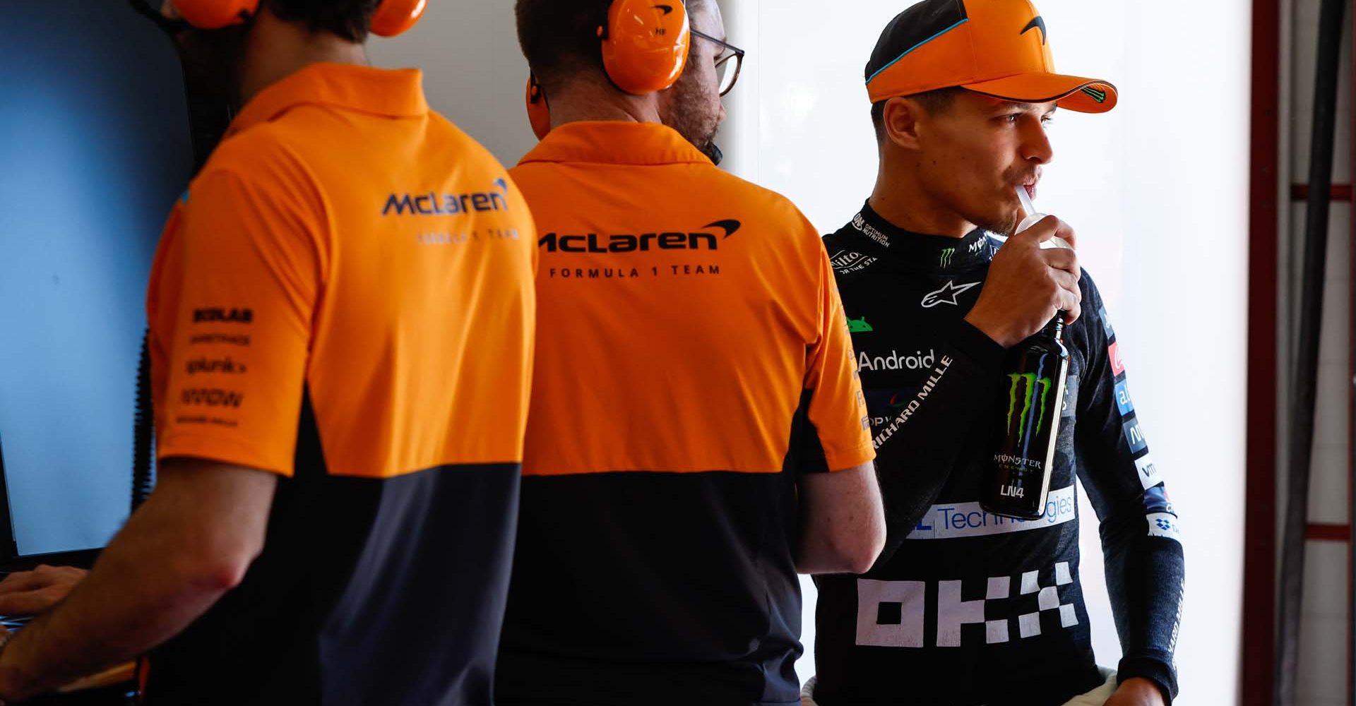 Lando Norris, McLaren F1 Team, with his engineers in the garage