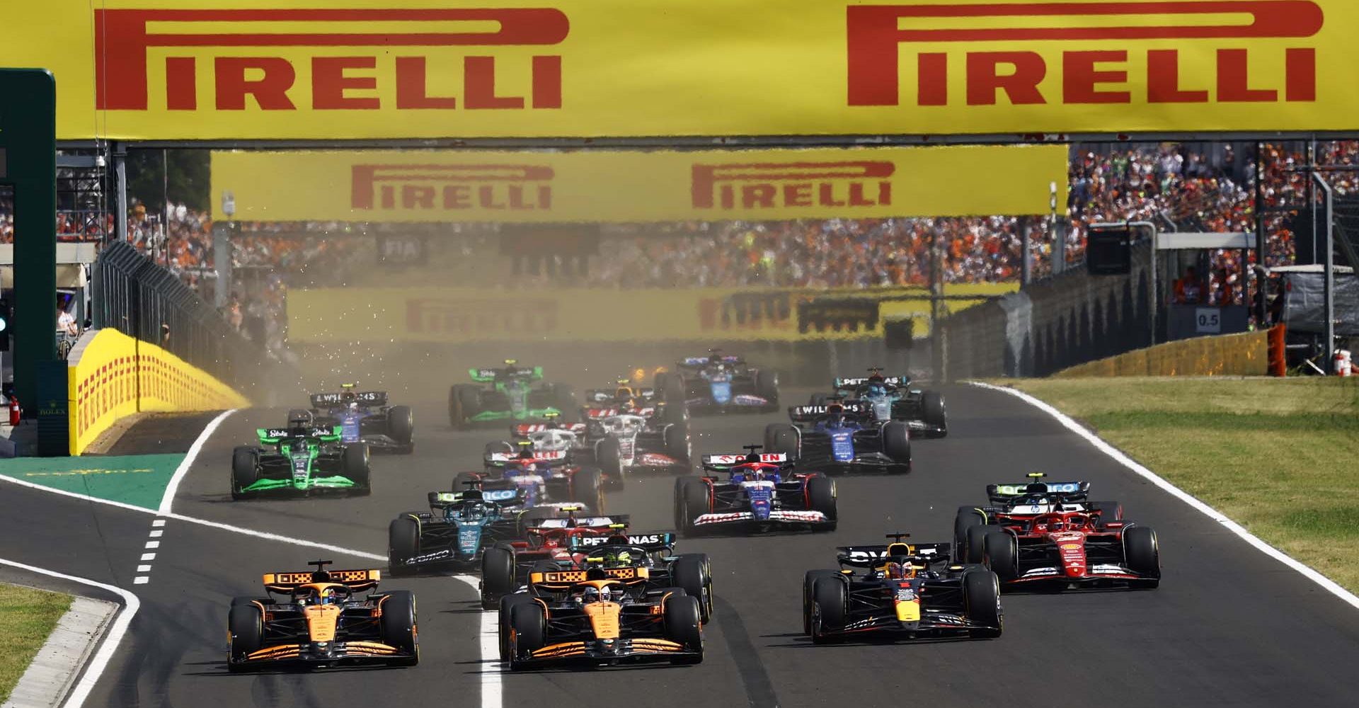 Lando Norris, McLaren MCL38, leads Max Verstappen, Red Bull Racing RB20, Oscar Piastri, McLaren MCL38, Fernando Alonso, Aston Martin AMR24, Charles Leclerc, Ferrari SF-24, Carlos Sainz, Ferrari SF-24, and the rest of the field at the start