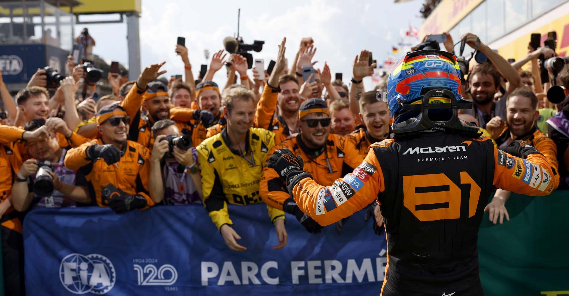 Oscar Piastri, McLaren F1 Team, 1st position, celebrates with his team on arrival in Parc Ferme