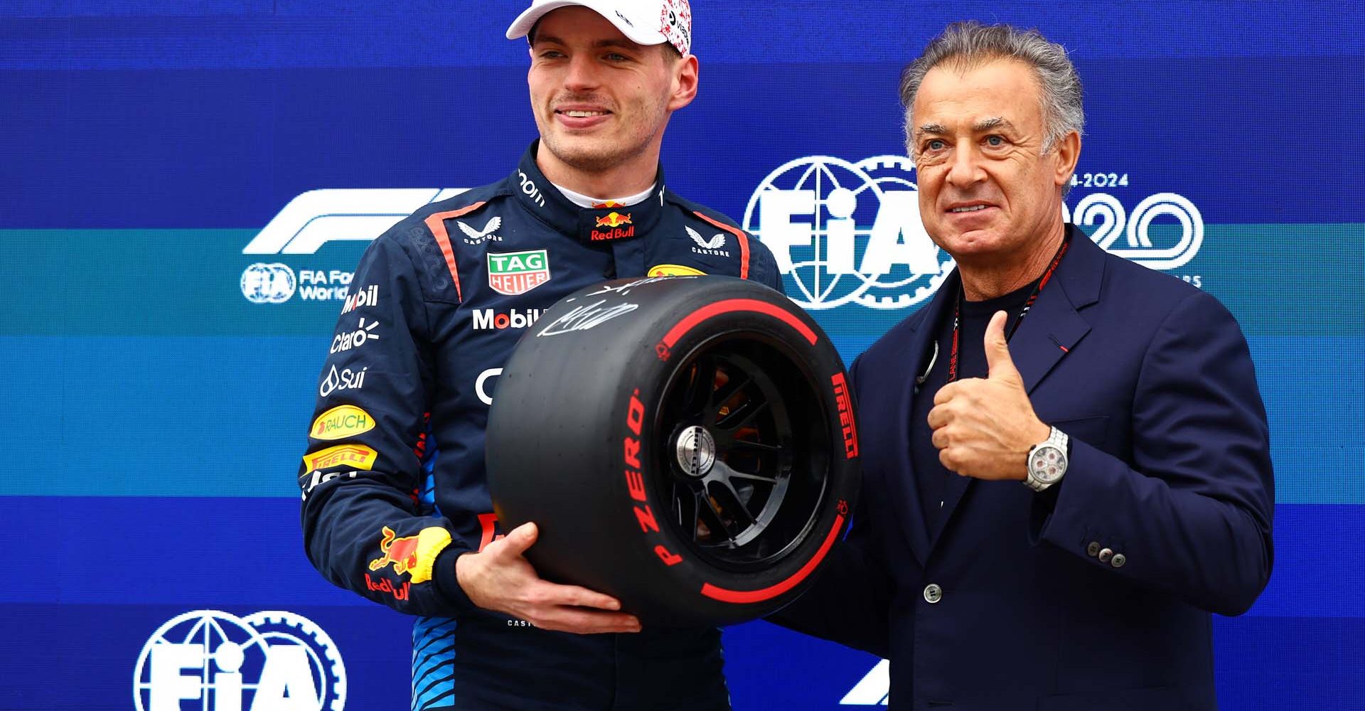 SUZUKA, JAPAN - APRIL 06: Pole position qualifier Max Verstappen of the Netherlands and Oracle Red Bull Racing is presented with the Pirelli Pole Position trophy by Jean Alesi in parc ferme during qualifying ahead of the F1 Grand Prix of Japan at Suzuka International Racing Course on April 06, 2024 in Suzuka, Japan. (Photo by Mark Thompson/Getty Images) // Getty Images / Red Bull Content Pool // SI202404060265 // Usage for editorial use only //