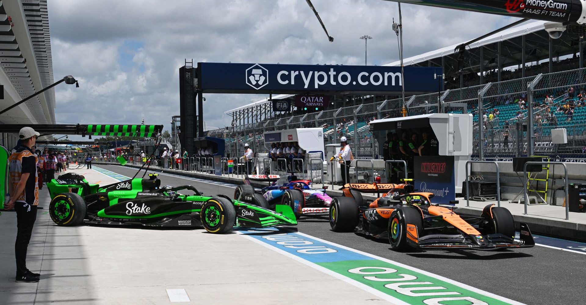 Lando Norris, McLaren MCL38, leads Zhou Guanyu, Stake F1 Team Kick Sauber C44, and Daniel Ricciardo, VCARB 01, out of the pits; 2024 Miami Grand Prix, Formula One World Championship