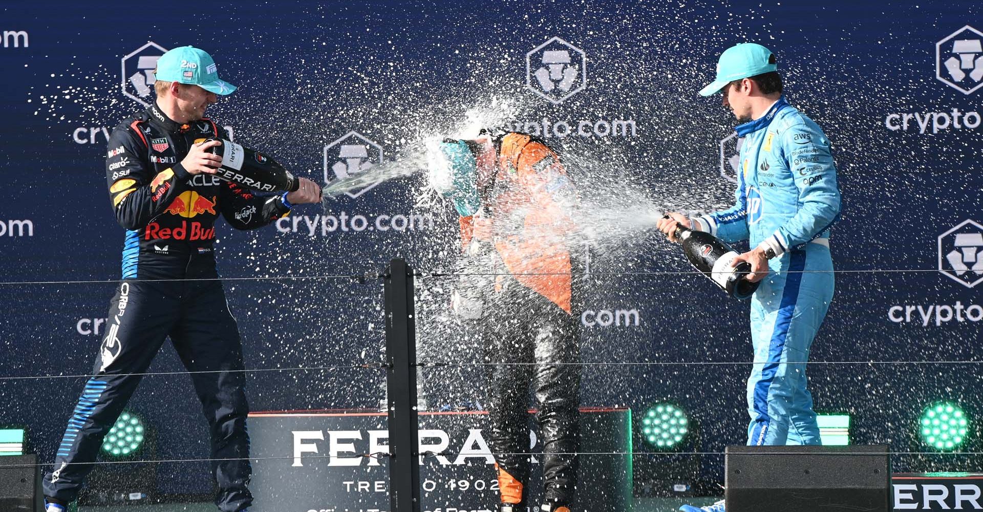 Max Verstappen, Red Bull Racing, 2nd position, Lando Norris, McLaren F1 Team, 1st position, and Charles Leclerc, Scuderia Ferrari, 3rd position, celebrate on the podium with Champagne