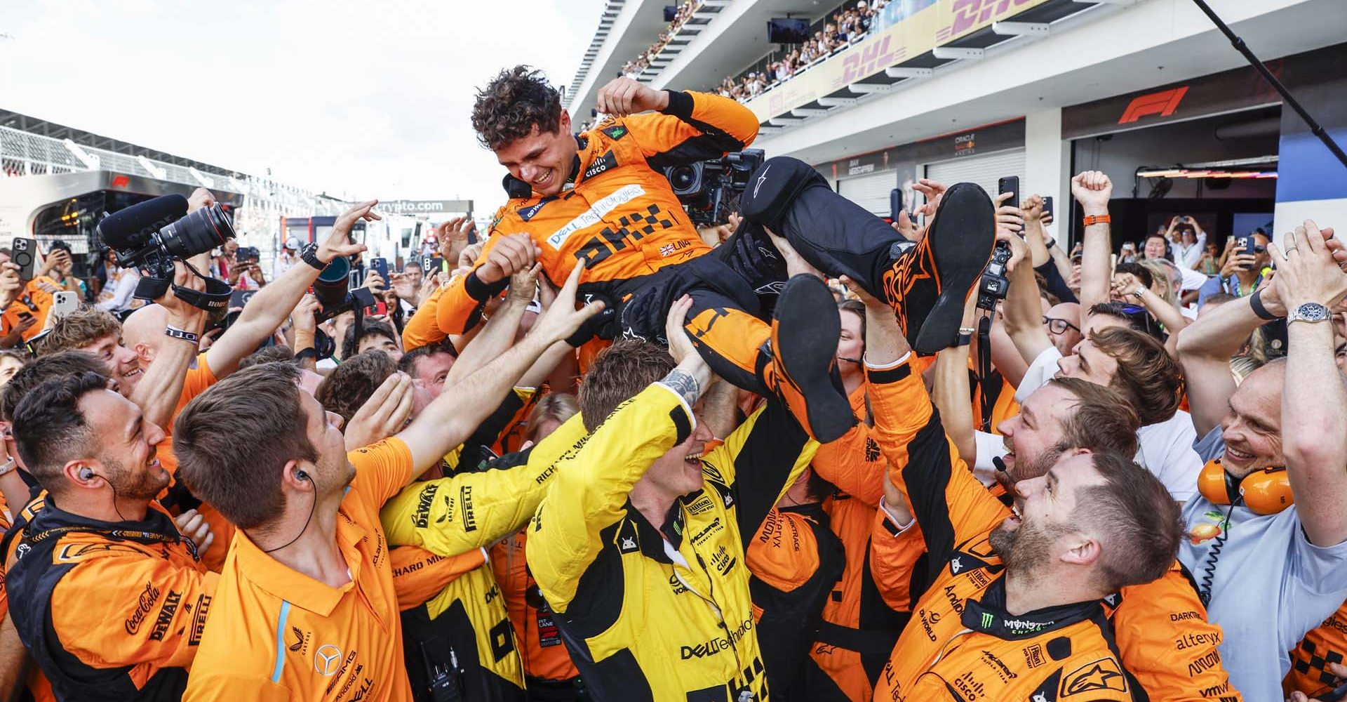 Lando Norris, McLaren F1 Team, 1st position, celebrates with his team on arrival in Parc Ferme