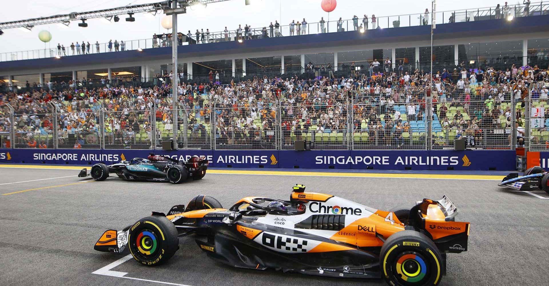 George Russell, Mercedes F1 W15, and Lando Norris, McLaren MCL38