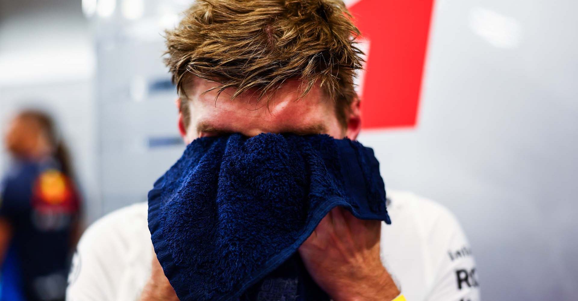 SINGAPORE, SINGAPORE - SEPTEMBER 20: Max Verstappen of the Netherlands and Oracle Red Bull Racing wipes his head with a towel in the garage during practice ahead of the F1 Grand Prix of Singapore at Marina Bay Street Circuit on September 20, 2024 in Singapore, Singapore. (Photo by Mark Thompson/Getty Images) // Getty Images / Red Bull Content Pool // SI202409200242 // Usage for editorial use only //