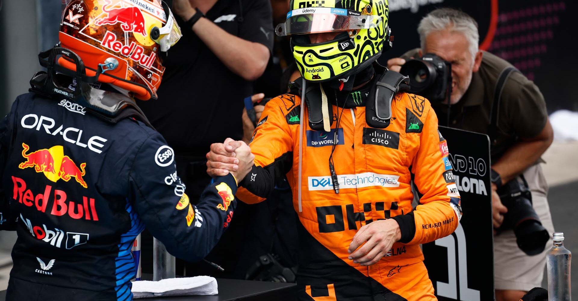 BARCELONA, SPAIN - JUNE 23: Second placed Lando Norris of Great Britain and McLaren shakes hands with Race winner Max Verstappen of the Netherlands and Oracle Red Bull Racing in parc ferme during the F1 Grand Prix of Spain at Circuit de Barcelona-Catalunya on June 23, 2024 in Barcelona, Spain. (Photo by Chris Graythen/Getty Images) // Getty Images / Red Bull Content Pool // SI202406230307 // Usage for editorial use only //