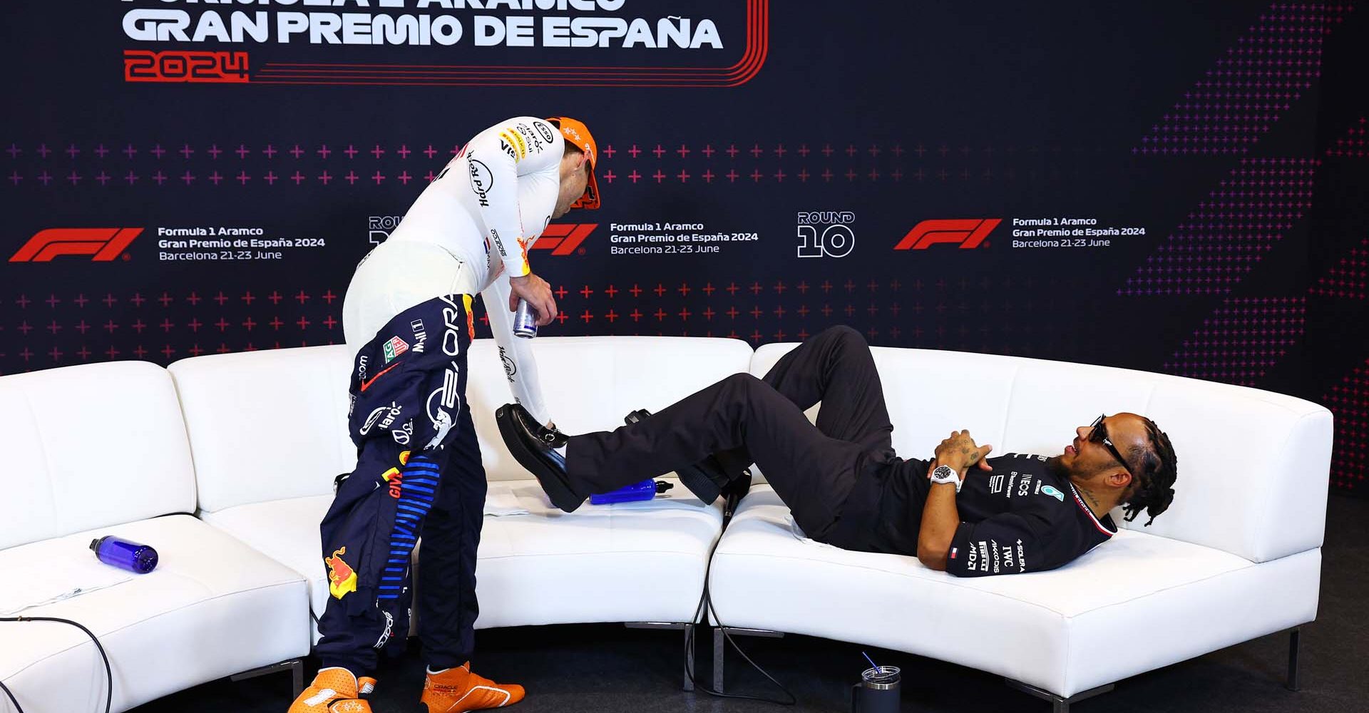 BARCELONA, SPAIN - JUNE 23: Third placed Lewis Hamilton of Great Britain and Mercedes lies on the softa as he waits for a press conference as Race winner Max Verstappen of the Netherlands and Oracle Red Bull Racing takes a seat after the F1 Grand Prix of Spain at Circuit de Barcelona-Catalunya on June 23, 2024 in Barcelona, Spain. (Photo by Clive Rose/Getty Images) // Getty Images / Red Bull Content Pool // SI202406230310 // Usage for editorial use only //