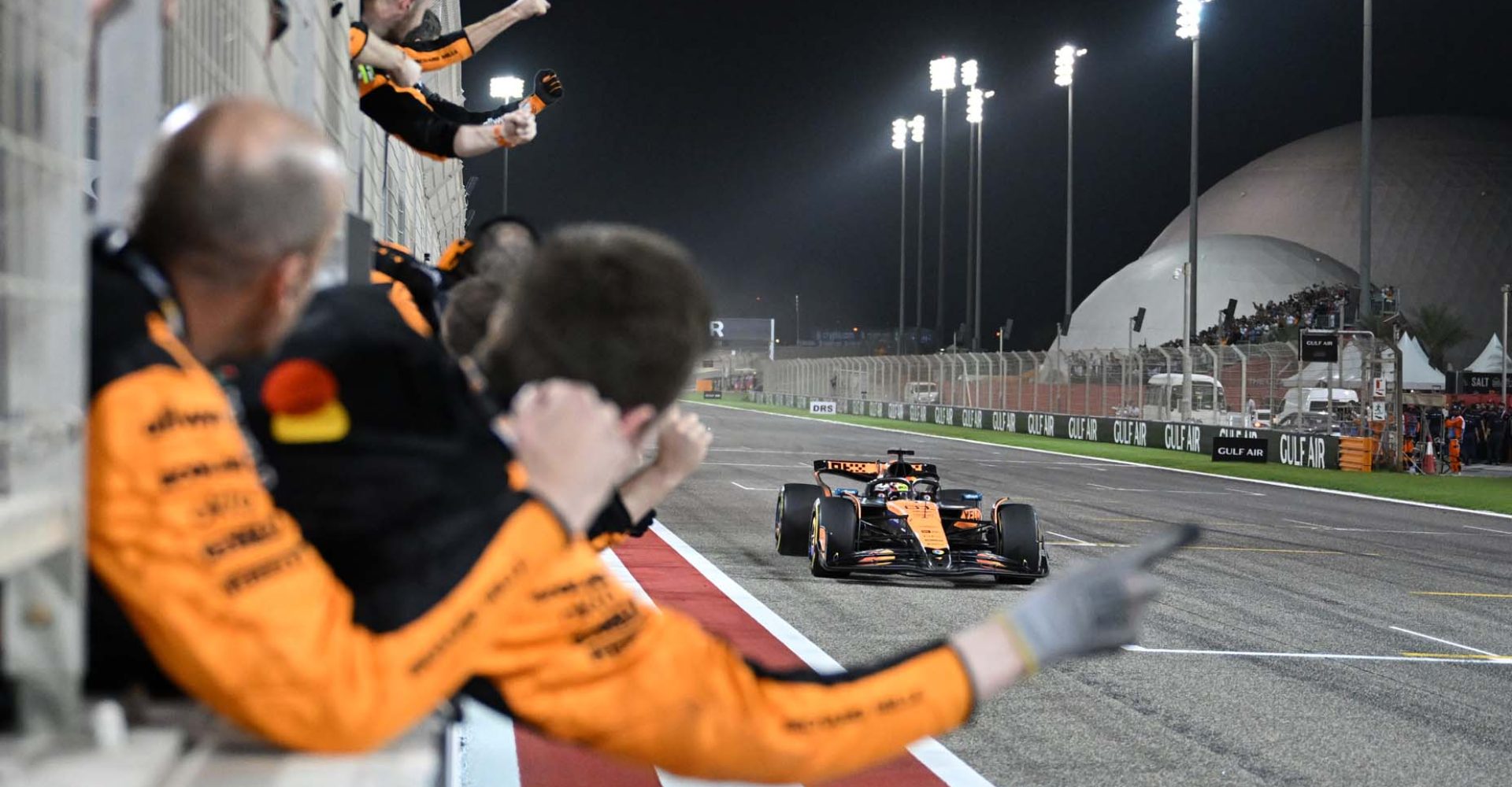 BAHRAIN, BAHRAIN - APRIL 13: Race winner Oscar Piastri of Australia driving the (81) McLaren MCL39 Mercedes crosses the line to cheers from his team on the pit wall during the F1 Grand Prix of Bahrain at Bahrain International Circuit on April 13, 2025 in Bahrain, Bahrain. (Photo by Sam Bagnall/Sutton Images)