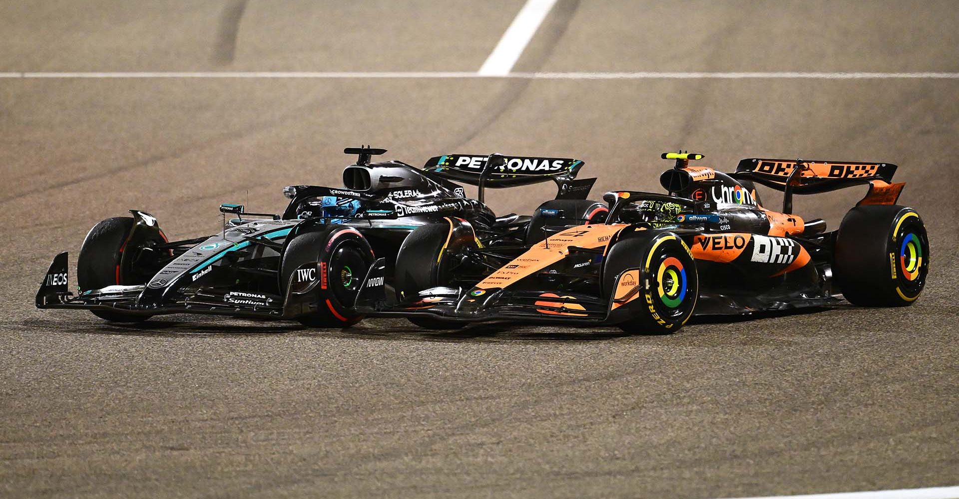 BAHRAIN, BAHRAIN - APRIL 13: George Russell of Great Britain driving the (63) Mercedes AMG Petronas F1 Team W16 and Lando Norris of Great Britain driving the (4) McLaren MCL39 Mercedes battle for track position on track during the F1 Grand Prix of Bahrain at Bahrain International Circuit on April 13, 2025 in Bahrain, Bahrain. (Photo by Clive Mason/Getty Images)