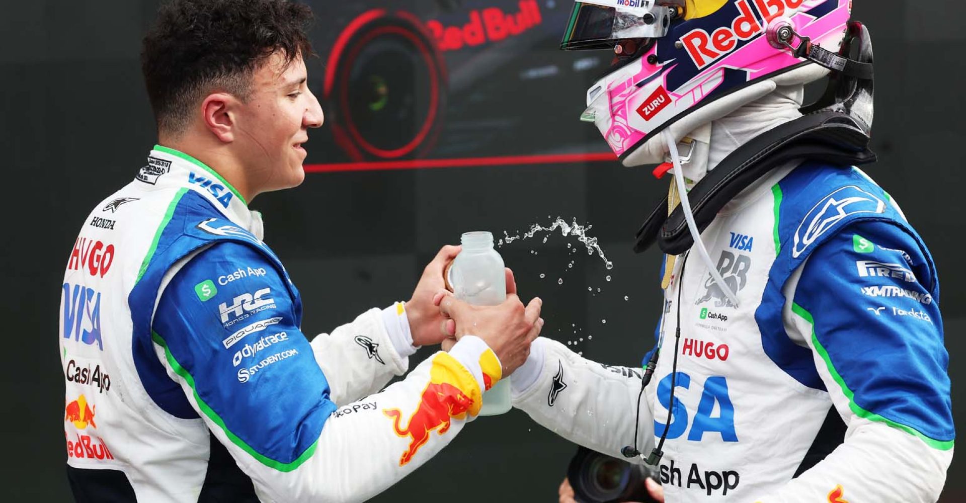 ZANDVOORT, NETHERLANDS - AUGUST 31: Twelfth placed Liam Lawson of New Zealand and Visa Cash App Racing Bulls congratulates Third placed Isack Hadjar of France and Visa Cash App Racing Bulls in parc ferme during the F1 Grand Prix of Netherlands at Circuit Zandvoort on August 31, 2025 in Zandvoort, Netherlands. (Photo by Mark Thompson/Getty Images) // Getty Images / Red Bull Content Pool // SI202508310375 // Usage for editorial use only //