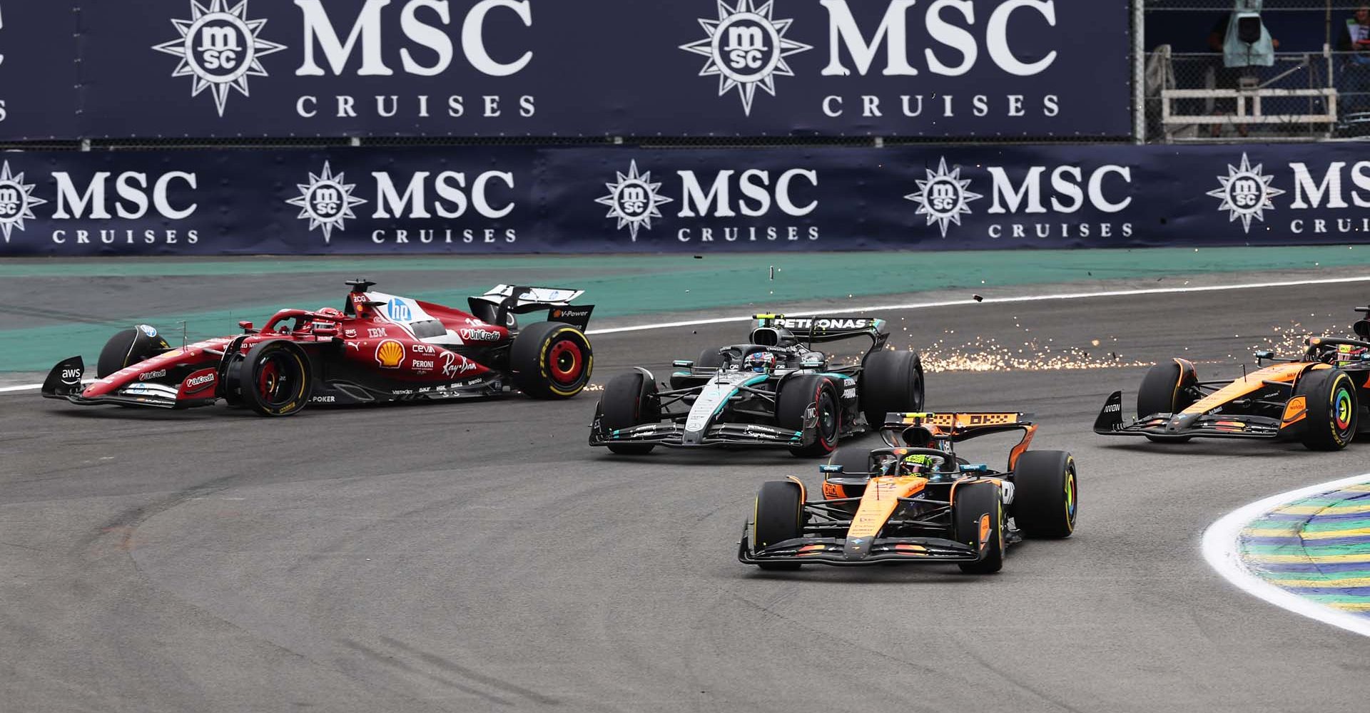SAO PAULO, BRAZIL - NOVEMBER 09: Lando Norris of Great Britain driving the (4) McLaren MCL39 Mercedes leads Andrea Kimi Antonelli of Italy driving the (12) Mercedes AMG Petronas F1 Team W16 and Oscar Piastri of Australia driving the (81) McLaren MCL39 Mercedes at the restart as Charles Leclerc of Monaco driving the (16) Scuderia Ferrari SF-25 crashes out during the F1 Grand Prix of Brazil at Autodromo Jose Carlos Pace on November 09, 2025 in Sao Paulo, Brazil. (Photo by Peter Fox/Getty Images)
