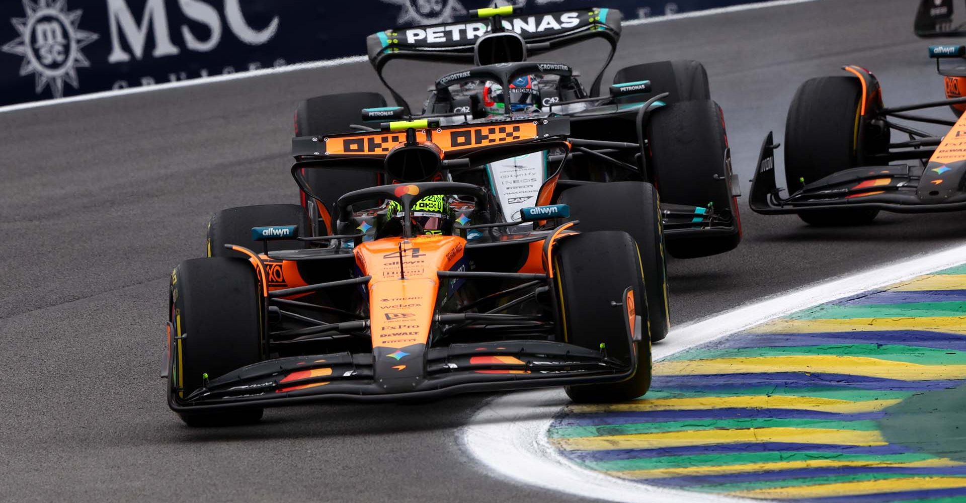 SAO PAULO, BRAZIL - NOVEMBER 09: Lando Norris of Great Britain driving the (4) McLaren MCL39 Mercedes leads as Andrea Kimi Antonelli of Italy driving the (12) Mercedes AMG Petronas F1 Team W16 and Oscar Piastri of Australia driving the (81) McLaren MCL39 Mercedes make contact during the F1 Grand Prix of Brazil at Autodromo Jose Carlos Pace on November 09, 2025 in Sao Paulo, Brazil. (Photo by Andy Hone/LAT Images)